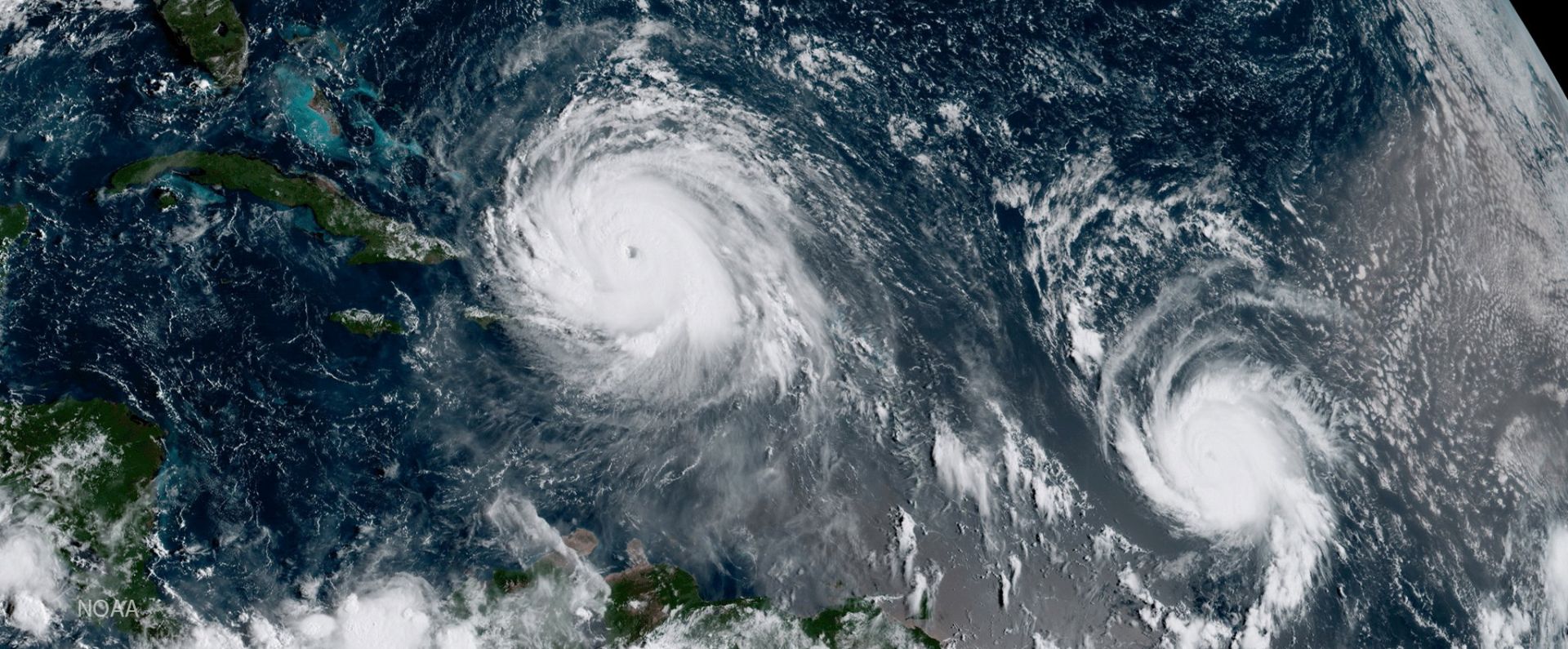 epa06191413 A handout image made available by The National Oceanic and Atmospheric Administration (NOAA) showing  geocolor image from GOES-16 shows Hurricane Irma (L) and Hurricane Jose (R) in the Atlantic Ocean on 07 September 2017. According to NOAA's National Hurricane Center, the category 5 Irma has maximum sustained winds of 180 miles per hour and is heading for the Turks and Caicos Islands. The storm is forecast to remain a powerful category 4 or 5 hurricane during the next couple of days. Jose, a category 1 storm, has maximum sustained winds of 90 miles per hour and is located about 815 miles east of the Lesser Antilles. Forecasters say Jose may strengthen during the next 48 hours.  EPA/NOAA / HANDOUT  HANDOUT EDITORIAL USE ONLY/NO SALES