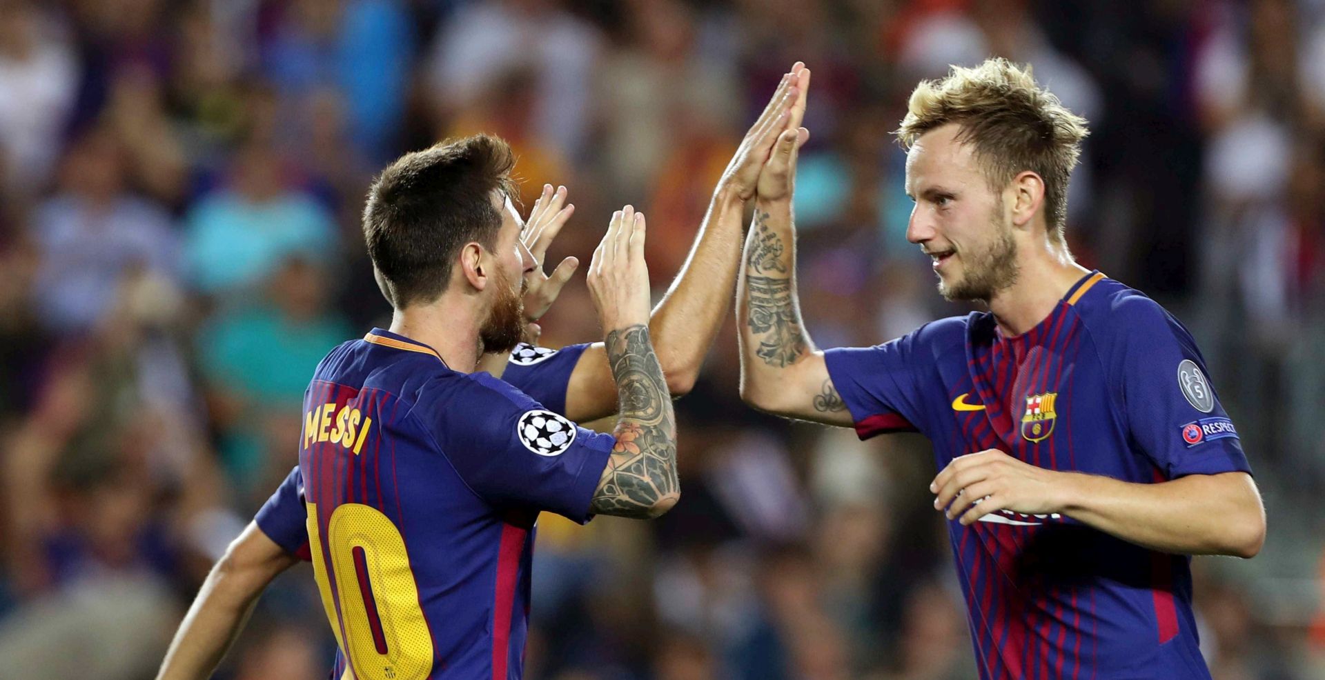 epa06200964 FC Barcelona's Lionel Messi (L) celebrates with teammate Ivan Rakitic after scoring a goal during the UEFA Champions League match between FC Barcelona and Juventus FC, in Barcelona, Catalonia, Spain, 12 September 2017.  EPA/TONI ALBIR