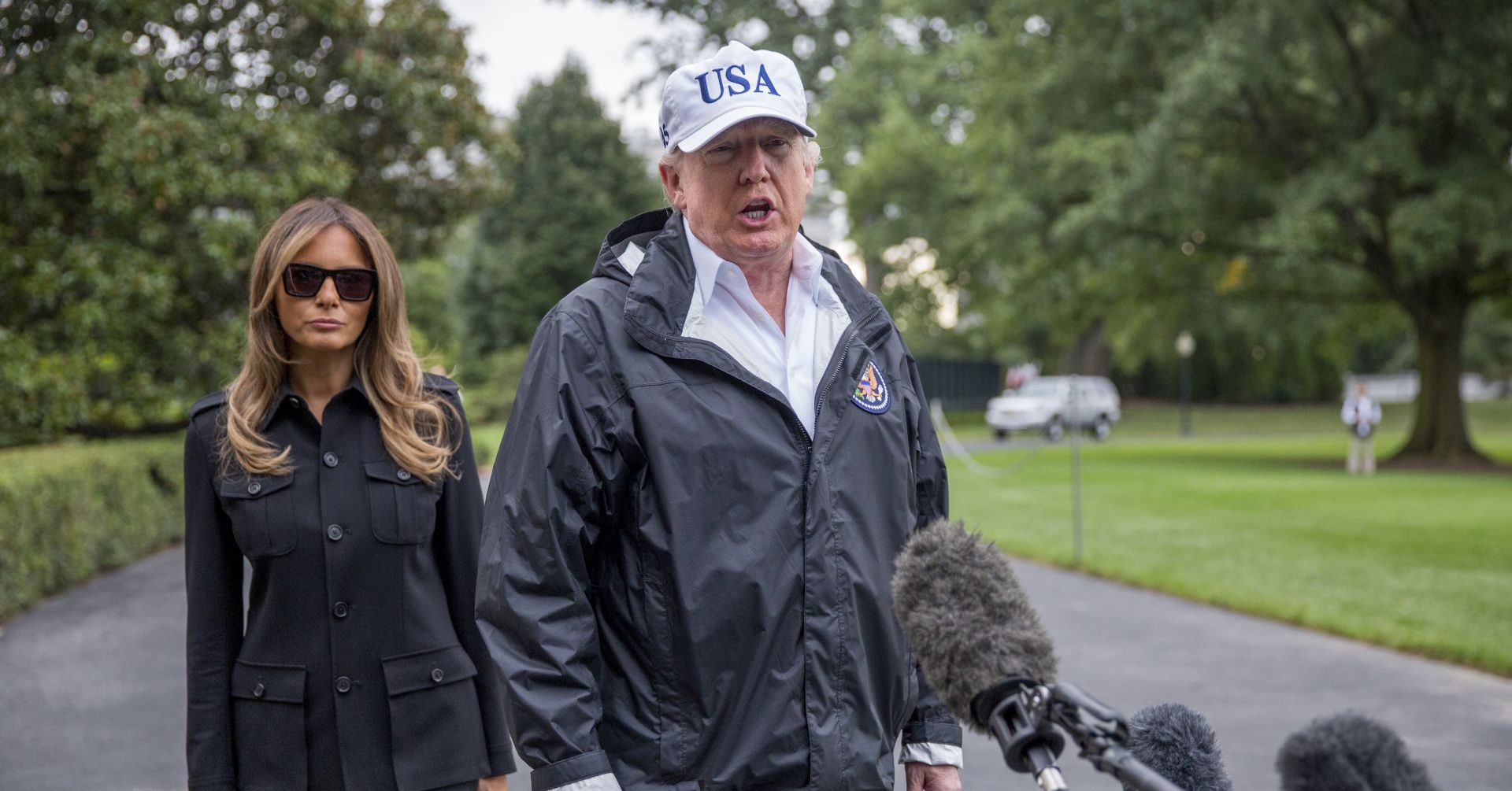epa06204181 US President Donald J. Trump (R), with First Lady Melania Trump (L), responds to questions from the news media prior to boarding Marine One on the South Lawn of the White House in Washington, DC, USA, 14 September 2017. President Trump responded to questions from the news media on federal response to the recent hurricanes and the prospect of a deal with Democratic leadership on DACA.  EPA/SHAWN THEW