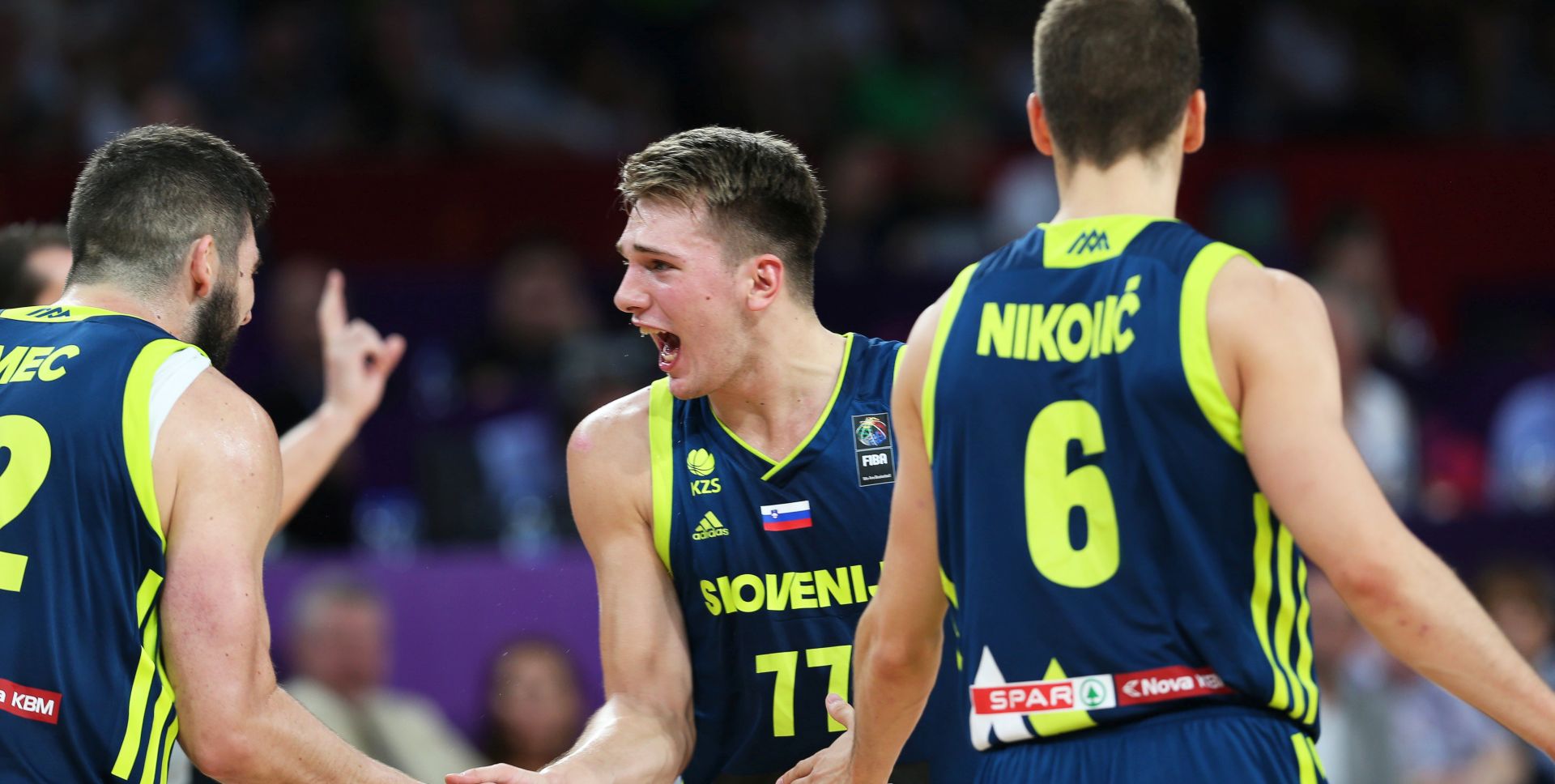 epa06205087 Slovenia's Luka Doncic (C) celebrates with his teammates Ziga Dimec (L) and Aleksej Nikolic (R) during the EuroBasket 2017 semi final match between Spain and Slovenia in Istanbul, Turkey, 14 September 2017.  EPA/TOLGA BOZOGLU