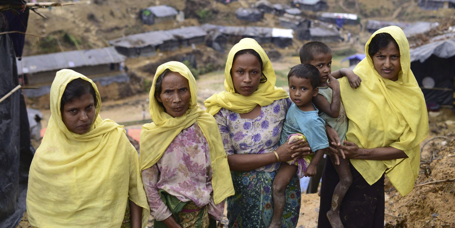 epa06213640 Rohingya refugees stand in front of a makeshift tent with their children in Ukhiya, Bangladesh, 19 September 2017. Myanmar's State Counsellor Aung San Suu Kyi said the governments of Myanmar and neighboring Bangladesh were working to resolve the humanitarian crisis caused by the exodus of mostly Rohingya refugees from Rakhine State. According to UNHCR more than 400 thousand Rohingya refugees have fled Myanmar from violence over the last few weeks, most trying to cross the border and reach Bangladesh. International organizations have reported claims of human rights violations and summary executions allegedly carried out by the Myanmar army.  EPA/STRINGER