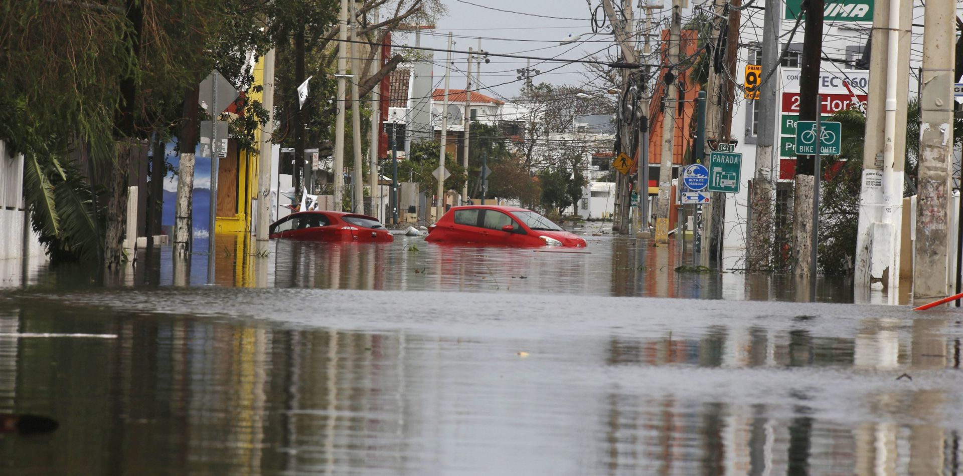 epa06220937 Cars remain on a flooded street in San Juan, Puerto Rico, 22 September 2017. Puerto Rico prepares to rebuild the island which is still experiencing communication problems, scarcity of water, food and gas, after Hurricane Maria left at least 12 dead.  EPA/THAIS LLORCA