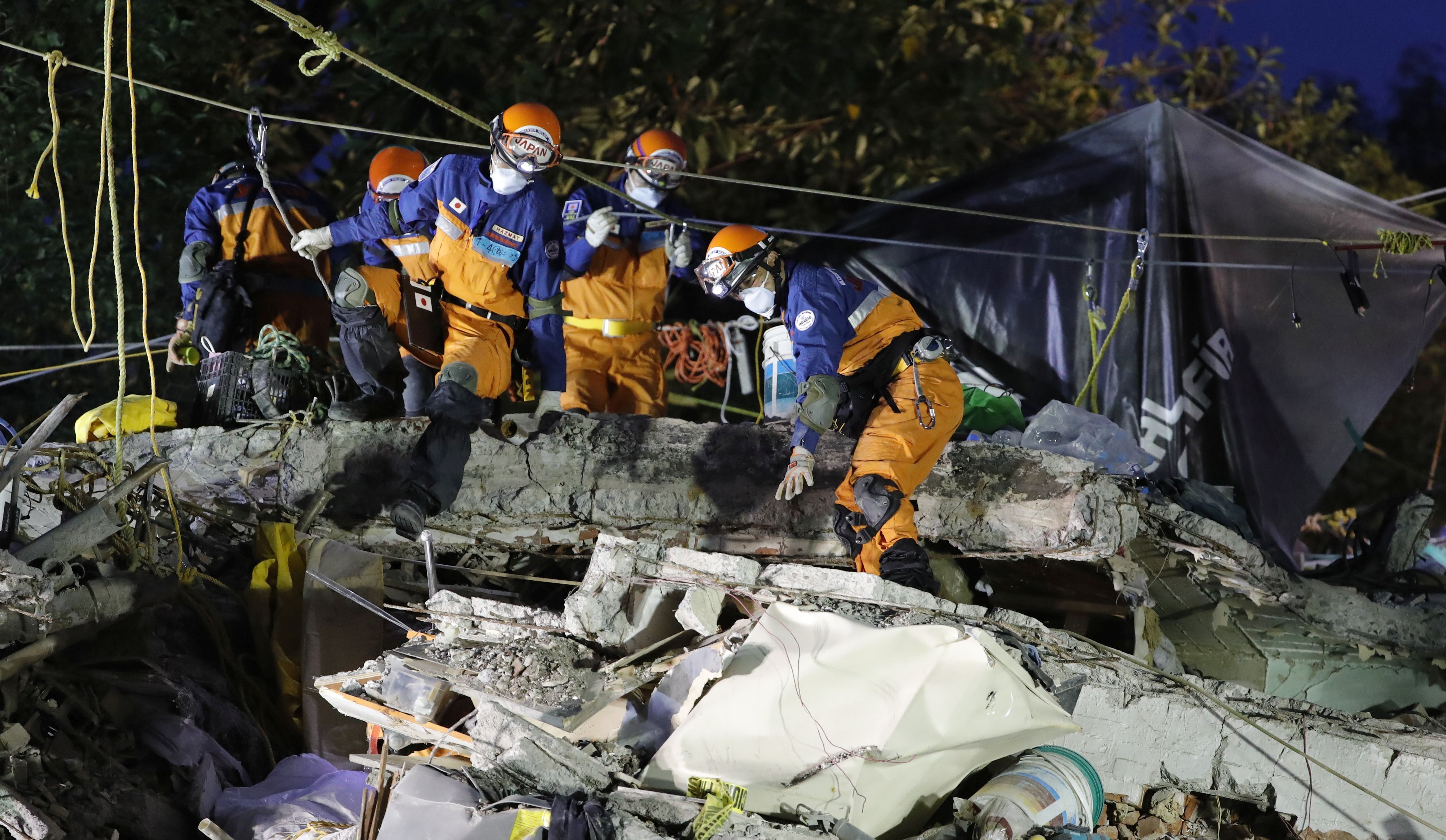 epa06222995 Japanese brigaders resume rescue efforts in a multi-family complex in Tlalpan, in Mexico City, Mexico, 23 September 2017. A new magnitude 6.4 earthquake struck central and southern Mexico today raising alarms, just four days after a powerful earthquake of 7.1 that has resulted in around 300 victims.  EPA/JOSE MENDEZ