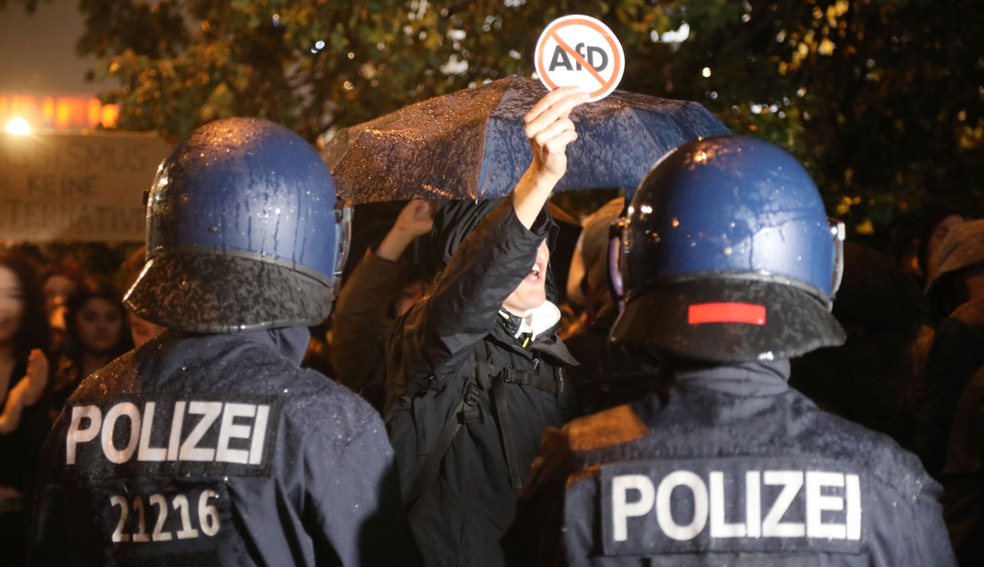 epa06224780 Police officers stand in front of protesters against the Alternative for Germany (AfD) party near to a night club where right-wing populist party AfD holds their election event in Berlin, Germany, 24 September 2017. According to federal election commissioner more than 61 million people were eligible to vote in the elections for a new federal parliament, the Bundestag, in Germany.  EPA/FOCKE STRANGMANN