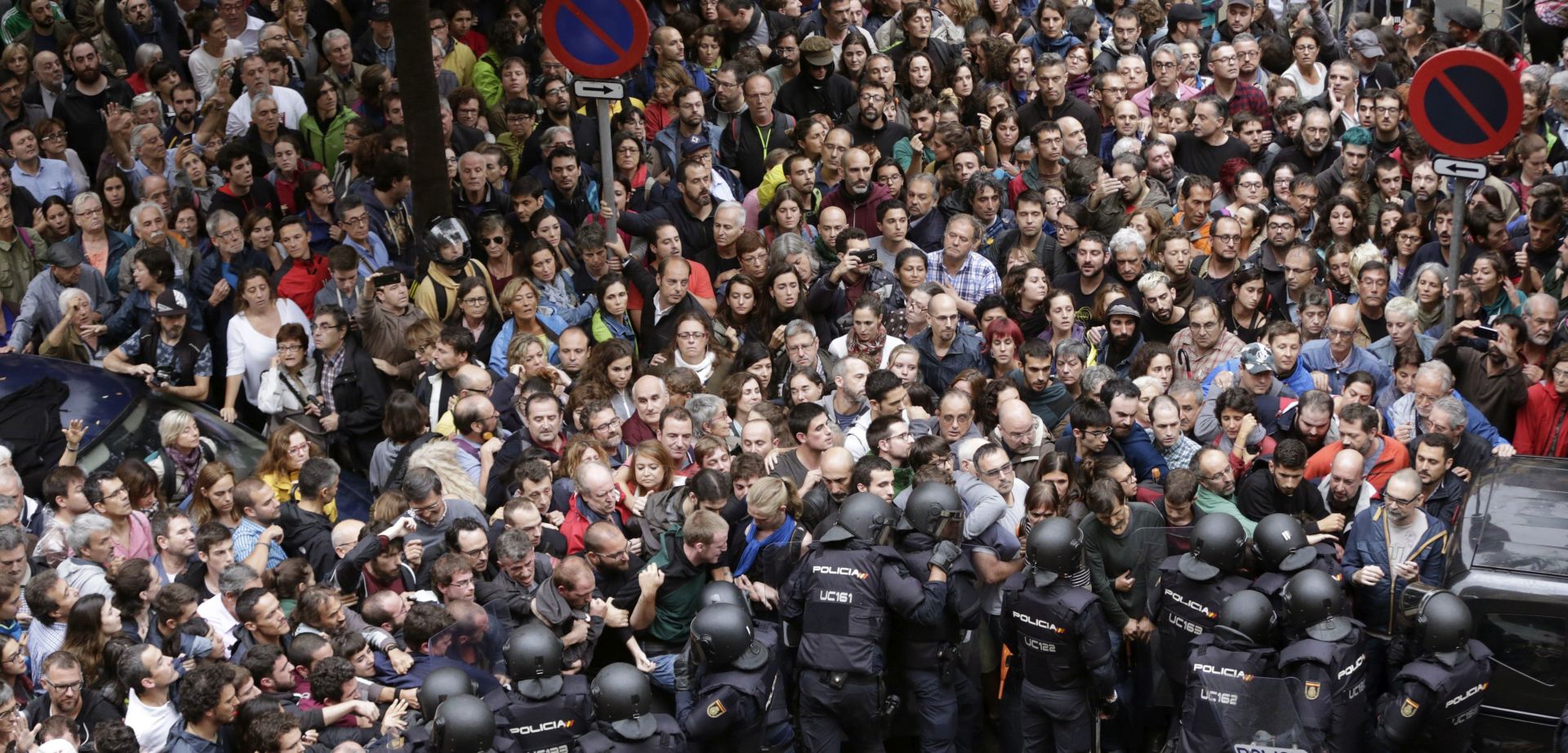 epa06237303 Spanish National riot policemen form a security cordon around the Ramon Llull school during the '1-O Referendum' in Barcelona, Catalonia, on 01 October 2017. National Police officers and Civil guards have been deployed to different polling centers in Barcelona to prevent the people from entering and vote in the Catalan independence referendum, that has been banned by the Spanish Constitutional Court. The police action has provocked clashes between pro-independence people and the police forces.  EPA/Alberto Estevez