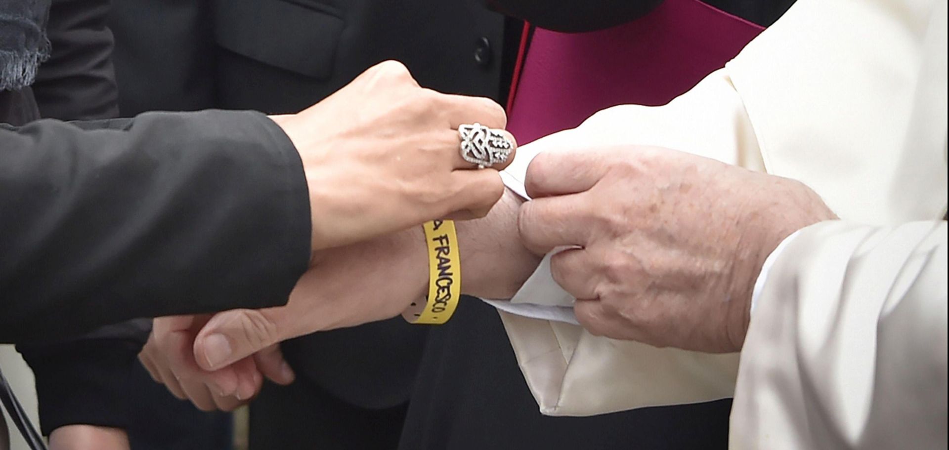 epa06238039 A handout picture provided by the Vatican newspaper L'Osservatore Romano shows Pope Francis (R) receives an identification bracelet before the meeting with migrants at a regional migrant center, in Bologna, Italy, 01 October 2017. Pope Francis is in Cesena and Bologna for a one-day visit.  EPA/OSSERVATORE ROMANO/HANDOUT  HANDOUT EDITORIAL USE ONLY/NO SALES