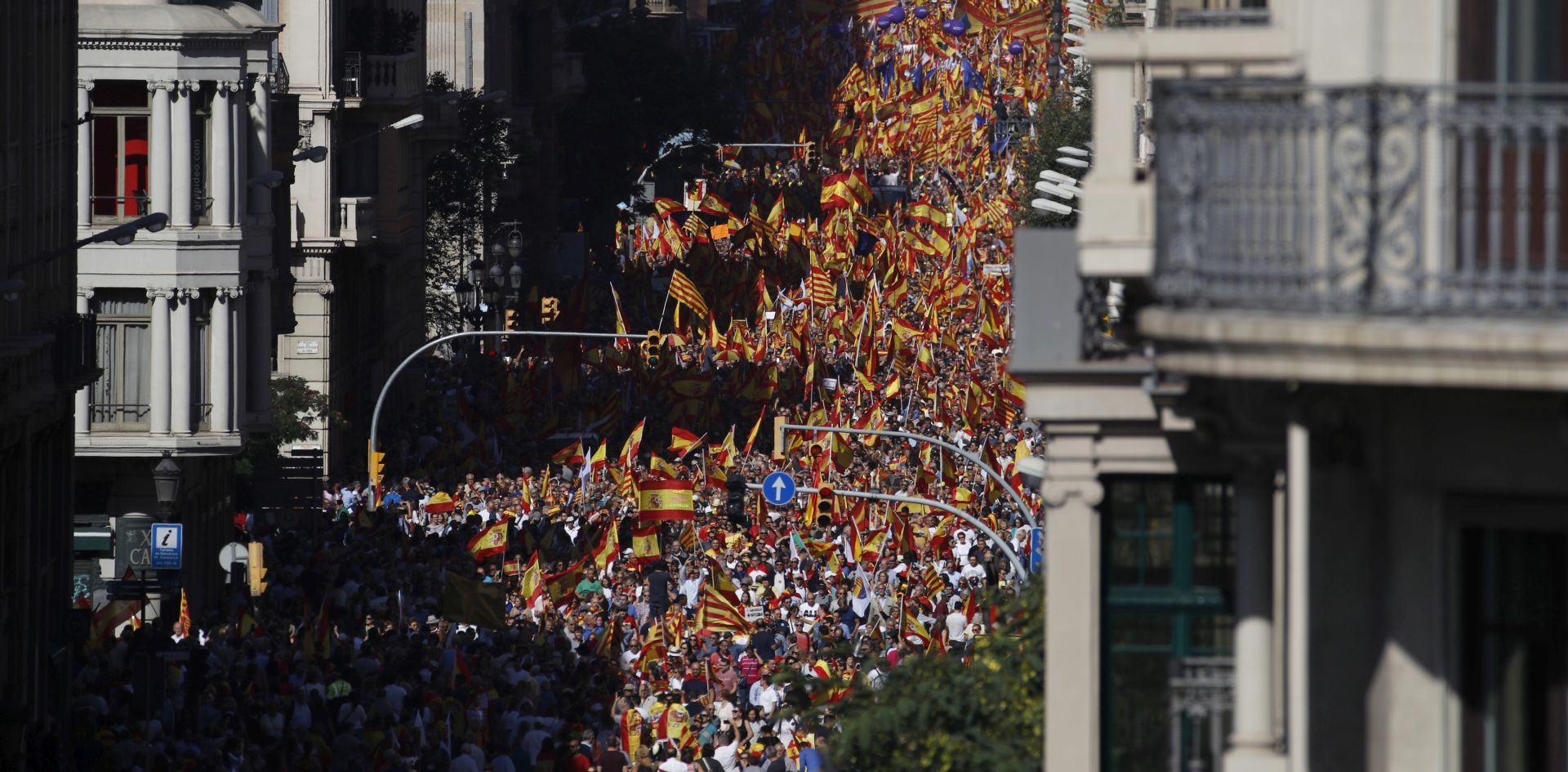 epa06252112 People with Spanish and Catalan flags gather ahead of a rally called by the 'Societat Civil Catalana' (Civil Catalan Society) at the Via Laietana street in Barcelona, Spain, 08 October 2017, to support the unity of Spain and its Constitution after the Catalan Independence Referendum held on 01 October which they claim was illegal.  EPA/ALBERTO ESTEVEZ