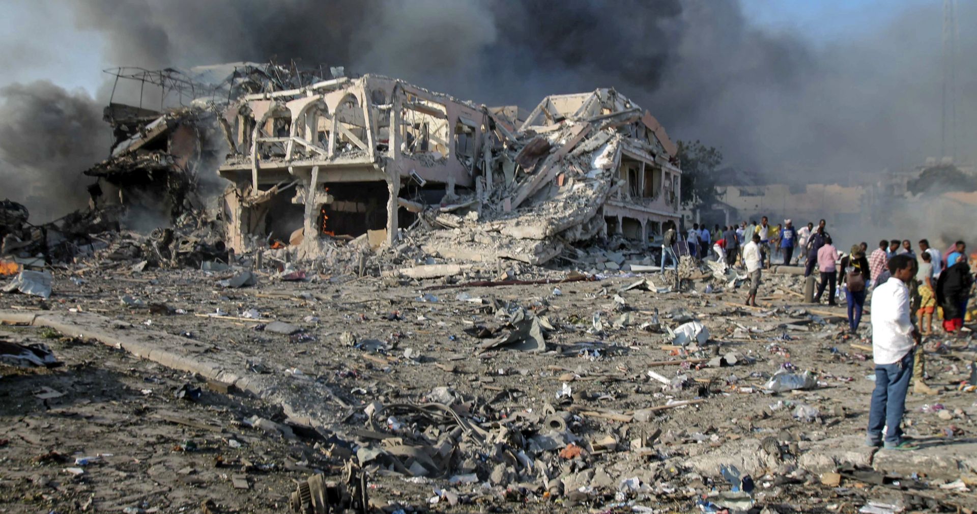 epa06267145 (FILE) - People gather at the scene of a massive explosion in front of Safari Hotel in the capital Mogadishu, Somalia, 14 October 2017 (reissued 15 October 2017). The death toll from the 14 October truck bomb attack has risen to at least 189, and more than 200 injured.  EPA/SAID YUSUF WARSAME