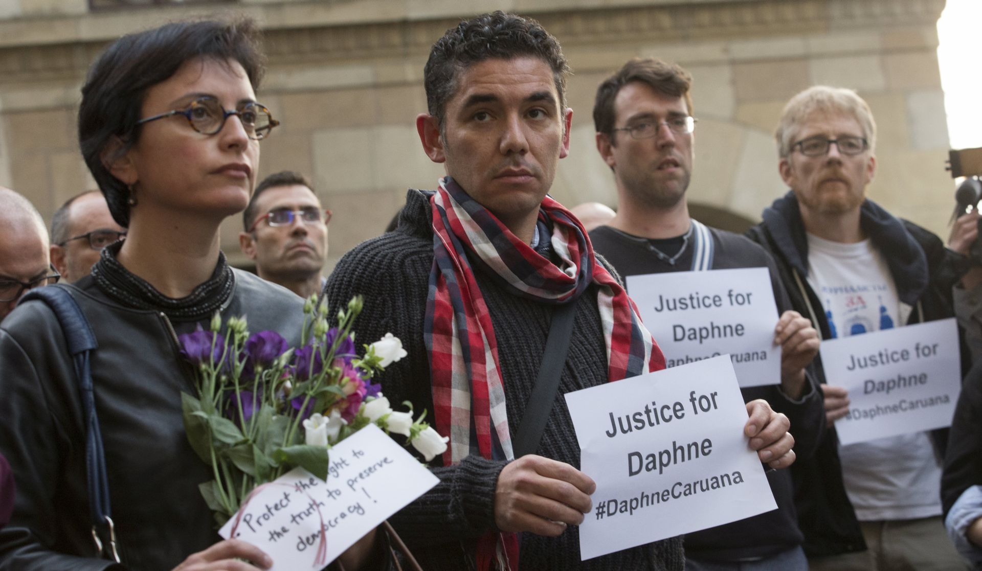 epa06273953 European journalists joined by EU commissioner during a silent vigil in memory of Maltese journalist Daphne  Caruana Galizia in Brussels Belgium, 18 October 2017. Daphne Caruana Galizia, 53, was killed in a car bombing near Mosta , Malta on 16 October . She was known for her blog accusing top politicians of corruption.  EPA/OLIVIER HOSLET