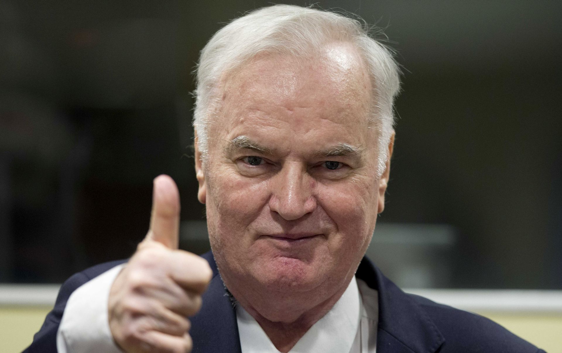 epa06343507 Bosnian Serb military chief Ratko Mladic shows a thumb up, as he enters the Yugoslav War Crimes Tribunal for the verdict hearing in his genocide trial, in The Hague, Netherlands, 22 November 2017. Mladic's trial is the last major case for the Netherlands-based tribunal for former Yugoslavia, which was set up in 1993 to prosecute those most responsible for the worst carnage in Europe, since World War II.  EPA/PETER DEJONG / POOL