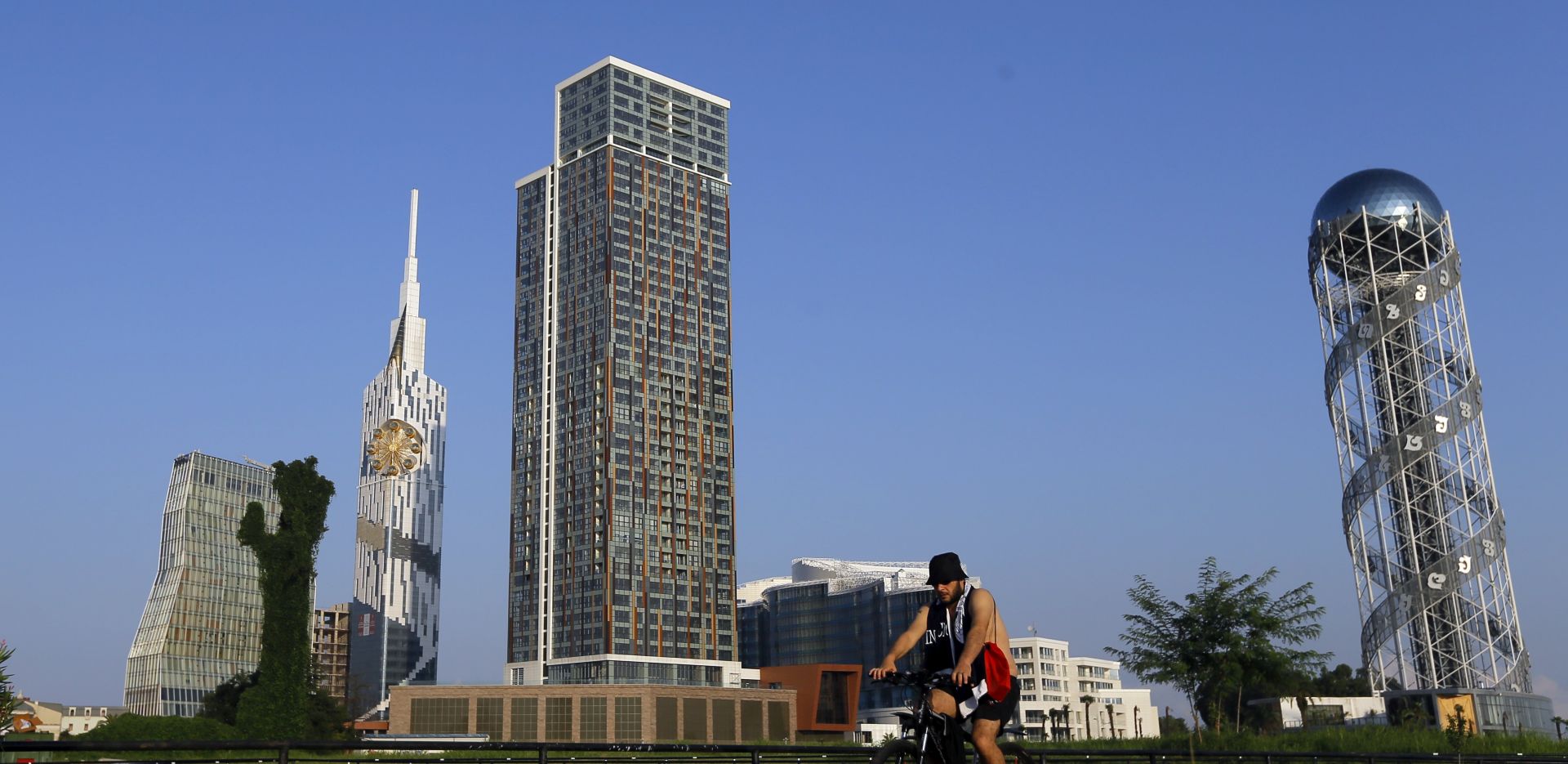 epa06349314 (FILE) - A general view of the new buildings as a cyclist passes in Batumi, Georgia, 21 August 2017 (reissued 25 November 2017). According to reports, a fire during the night of late 24 November 2017 left at least twelve people dead and dozens injured at an upmarket in the Black Sea resort city of Batumi, western Georgia.  EPA/ZURAB KURTSIKIDZE *** Local Caption *** 53716410