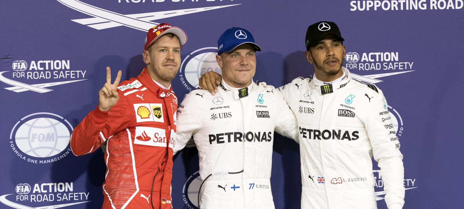 epa06350064 German Formula One driver Sebastian Vettel (L) of Scuderia Ferrari, Finnish driver Valtteri Bottas (C) and his British teammate Lewis Hamilton (R), both of Mercedes AMG GP, pose for photographers after the qualifying session at Yas Marina Circuit in Abu Dhabi, United Arab Emirates, 25 November 2017. Bottas took the pole position ahead of second placed Hamilton and third placed Vettel. The Formula One Grand Prix of Abu Dhabi will take place on 26 November 2017.  EPA/VALDRIN XHEMAJ