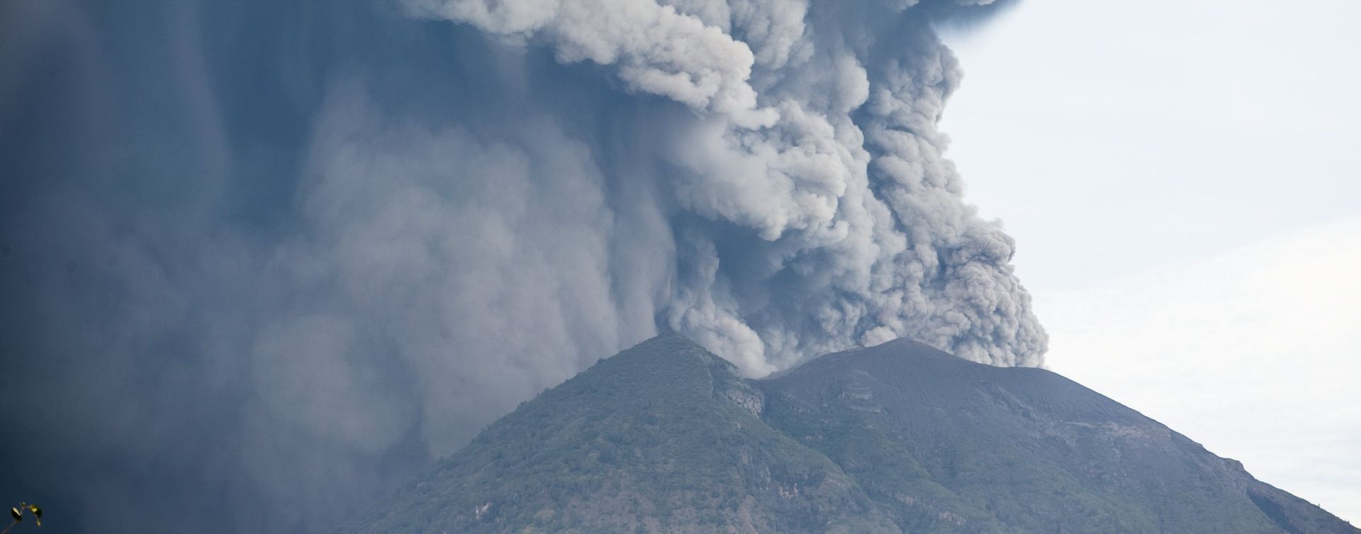epa06351206 The Mount Agung volcano spews volcanic ash in Karangasem, Bali, Indonesia, 26 November 2017. According to reports from the Energy and Mineral Resources Ministry's Volcanology and Geological Hazard Mitigation Center (PVMBG), the volcano has erupted and is spewing an ash cloud more than 1,500 meters in height. The airlines Jetstar and Quantas have cancelled all flights to and from Bali as a result of the eruption.  EPA/MADE NAGI