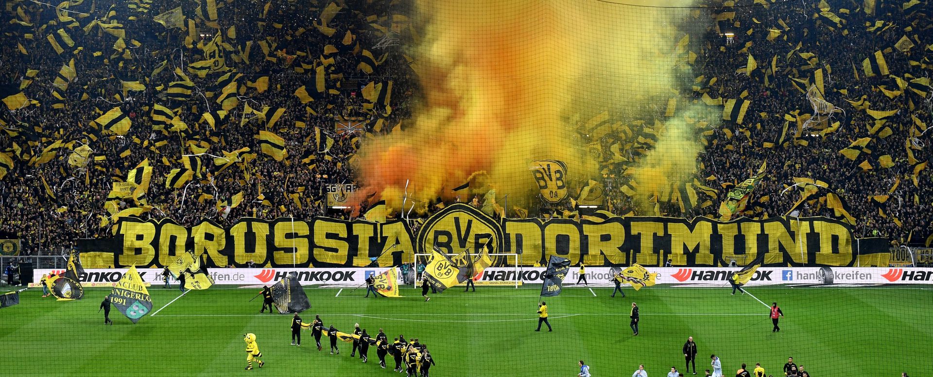 epa06350100 Dortmund supporters in the stands cheer for their teasm prior to the German Bundesliga soccer match between Borussia Dortmund and FC Schalke 04 in Dortmund, Germany, 25 November 2017.  EPA/SASCHA STEINBACH EMBARGO CONDITIONS - ATTENTION: Due to the accreditation guidelines, the DFL only permits the publication and utilisation of up to 15 pictures per match on the internet and in online media during the match.