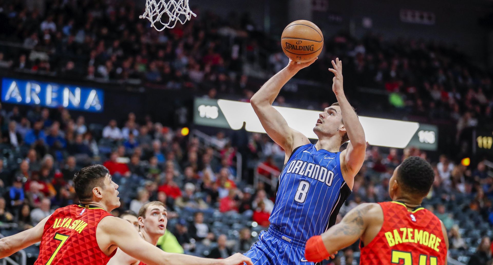 epa06380300 Orlando Magic guard Mario Hezonja (C) of Croatia shoots against Atlanta Hawks forward Ersan Ilyasova (L) of Turkey and Hawks guard Kent Bazemore (R) during the first half of the NBA basketball game between the Orlando Magic and the Atlanta Hawks at Philips Arena in Atlanta, Georgia, USA, 09 December 2017.  EPA/ERIK S. LESSER