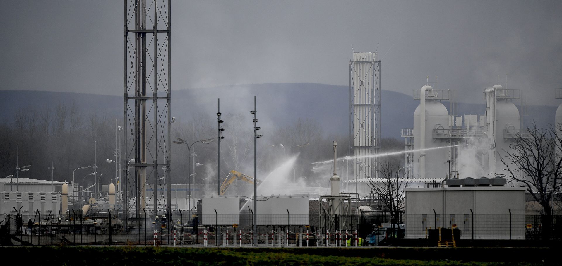 epa06384514 Firefighters at the scene of an explosion at a gas hub of OMV in Baumgarten, Austria, 12 December 2017. According to reports by the Red Cross, at least one person has died and 18 others have been injured in a gas explosion in Baumgarten.  EPA/CHRISTIAN BRUNA