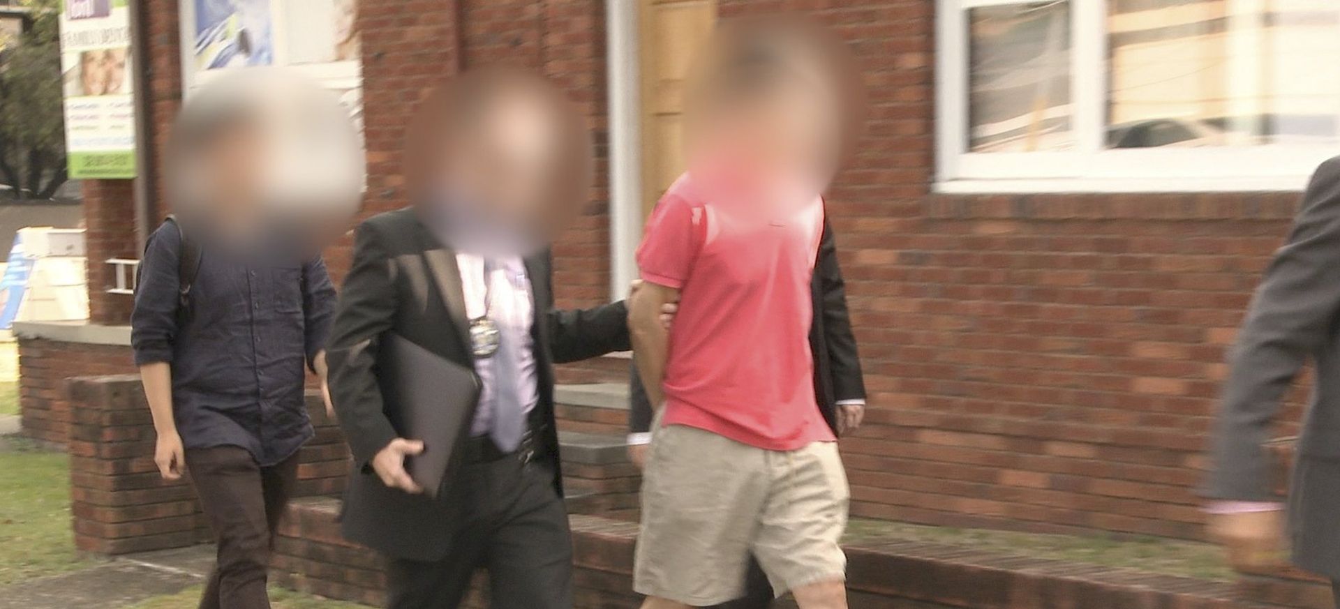 epa06394525 A handout photo made available by the Australian Federal Police on 17 December 2017 shows Australian Federal Police officers arrest a man (C) during operation BYAHAUT, in Sydney, Australia. The Australian Federal Police (AFP) arrested a 59-year-old Sydney man for allegedly acting as an economic agent for the Democratic People's Republic of Korea Government (North Korea) in Australia, in breach of both United Nations (UN) and Australian sanctions. Notably, the man has also been charged with brokering sales and discussing the supply of weapons of mass destruction. Operation BYAHAUT commenced earlier this year when a 59-year-old man from Eastwood, NSW, was identified as a person of interest to the AFP.  EPA/AUSTRALIAN FEDERAL POLICE / HANDOUT IMAGE PIXELATED AT SOURCE HANDOUT EDITORIAL USE ONLY/NO SALES