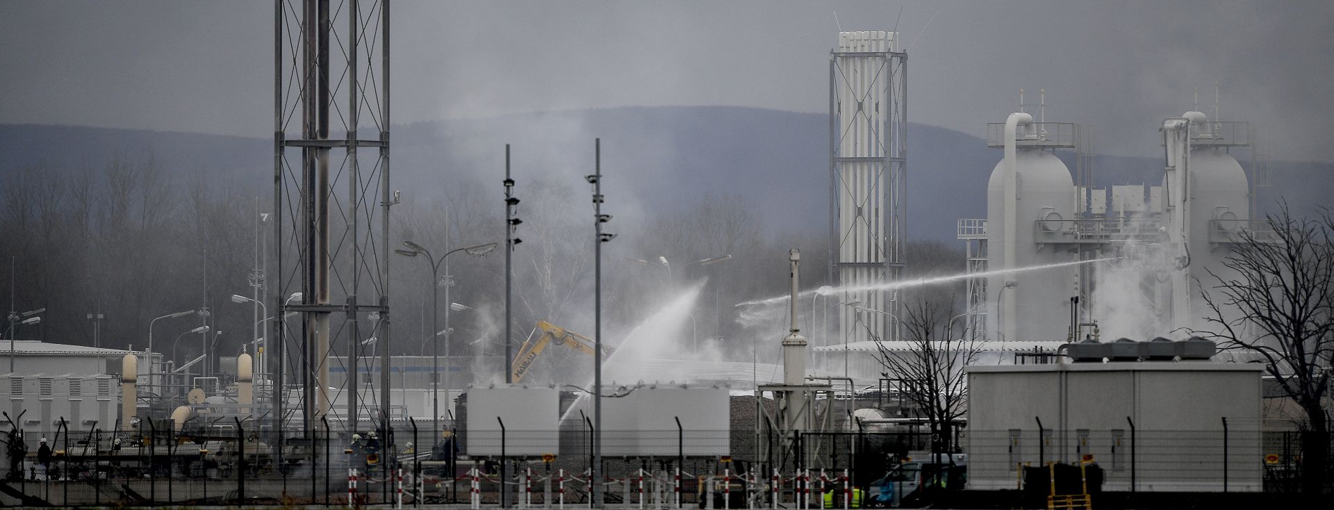 epa06384514 Firefighters at the scene of an explosion at a gas hub of OMV in Baumgarten, Austria, 12 December 2017. According to reports by the Red Cross, at least one person has died and 18 others have been injured in a gas explosion in Baumgarten.  EPA/CHRISTIAN BRUNA
