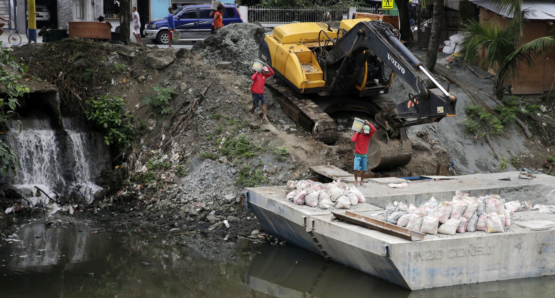 epa06392650 Filipino laborers are seen at a flood control project in Bacoor city, Cavite province, Philippines, 16 December 2017. The National Disaster Risk Reduction and Management Council (NDRRMC) reported that at least three people were killed and six were missing as Tropical Storm Kai-Tak made landfall in Samar island. Reports reach the NDRRMC office of unpassable roads due to landslides and floods, residents were evacuated, and domestic flights were cancelled in affected areas.  EPA/FRANCIS R. MALASIG