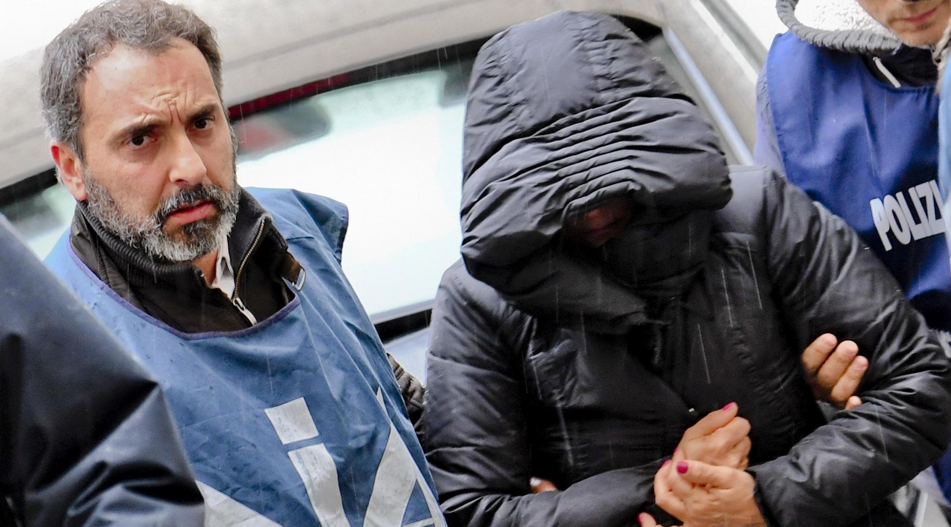epa06387189 One unidentified woman is escorted by police to the prison in Naples, 13 December 2017. Four women related to Michele Zagaria, the boss of the Casalesi clan of the Camorra mafia, were arrested on Wednesday. The women are suspected to be the clan's paymasters, as they were tasked with paying its members' monthly 'salaries'.  EPA/CIRO FUSCO