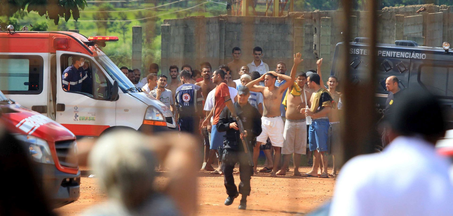 epa06413124 A handout photo made available by O Popular shows a group of inmates guarded by the authorities at a prison in the metropolitan region of Goiania, capital of the Brazilian state of Goias, Brazil, 01 January 2018. At least 9 people died and fourteen were injured during clashes when a group of prisoners invaded a pavilion of the Aparecida Prison Complex in Goiania where there were inmates of a rival camp.  EPA/Claudio Reis HANDOUT  HANDOUT EDITORIAL USE ONLY/NO SALES