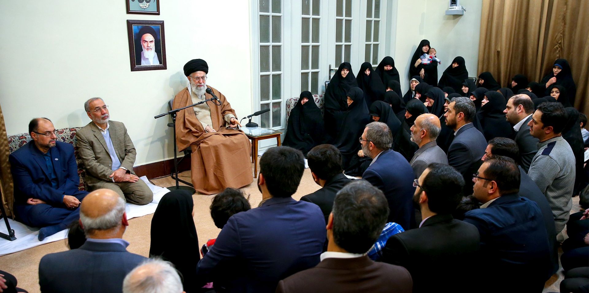 epa06413436 A handout photo made available by the Supreme leader official website shows, Iranian Supreme leader Ayatollah Ali Khamenei (L), sitting under a portrait of the late Iranian revolutionary founder Ayatollah Khomeini, as he speaks during a meeting with family members of Iranian martyrs, in Tehran, Iran, 02 January, 2018. Media reported that Khamenei said the protests against the Islamic establishment controlled by foreign countries. 'The enemies of Iran have in recent days provided the troublemakers with money, weapons and political support to harm Iran,' he added.  EPA/Supreme leader official website/ HANDOUT  HANDOUT EDITORIAL USE ONLY/NO SALES