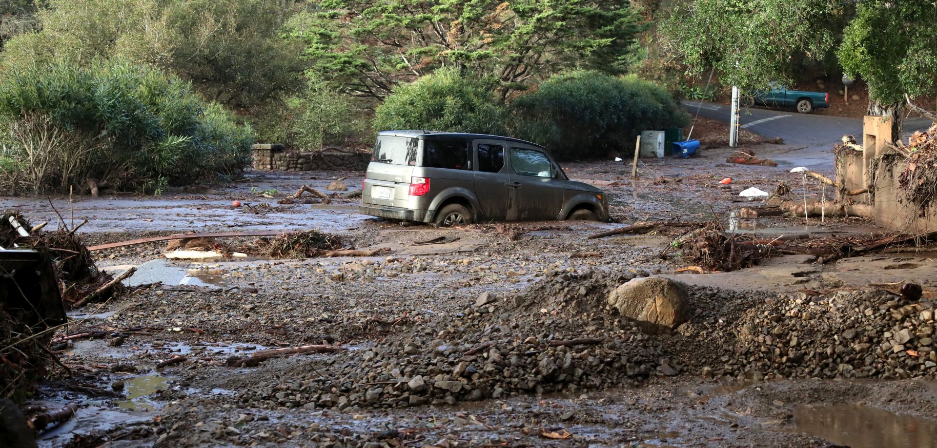 epa06428033 A car is trapped in a mudslide following heavy rains in Montecito, California, USA, 09 January 2018.  A rain storm in southern California has destroyed several homes and killed at least 13 people in Montecito, California and closed a 35 mile stretch of the 101 freeway.  EPA/MIKE NELSON
