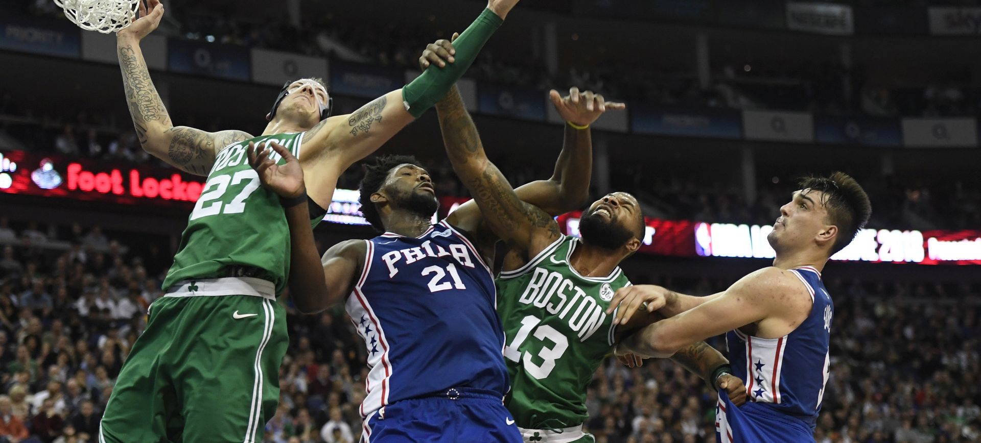 epa06431984 Daniel Theis (L), Marcus Morris (2-R) of the Boston Celtics compete for the ball against Joel Embiid (2-L) and Dario Saric (R) of the Philadelphia 76ers during an NBA game at the O2 Arena in London, Britain, 11 January 2018.  EPA/WILL OLIVER