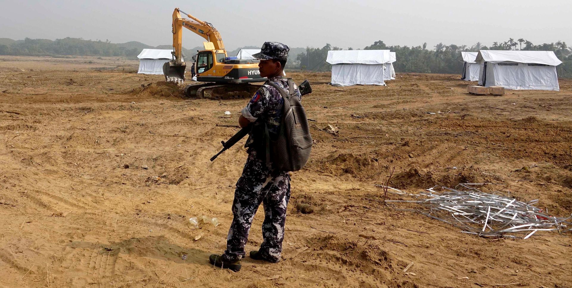 epa06438007 A soldier stands near the makeshift tents for Rohingya people, locally called Bangali, who will be repatriated from Bangladesh, in Maungdaw township, Rakhine State, western Myanmar, 14 January 2018. According to the United Nations High Commissioner for Refugees (UNHCR), more than 650,000 Rohingya refugees have fled Myanmar since the army launched a military offensive on 25 August 2017 the after Rohingya rebels had mounted a series of attacks on multiple government posts.  EPA/NYUNT WIN