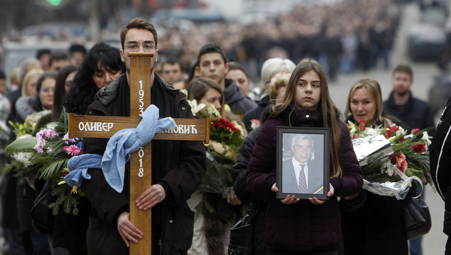 epa06446626 Citizens of northern Kosovska Mitrovica join a mourning procession of friends, relatives and companions for slain Oliver Ivanovic, in Mitrovica in northern Kosovo, Serbia, 17 January 2018. Around a thousand citizens of Mitrovica reportedly accompanied the coffin with the remains of Oliver Ivanovic in a procession through the streets of Mitrovica. Ivanovic, a former State Secretary for Kosovo and Metohija and a subject of a controversial war crimes trial and retrial, was fatally shot in front of his office in Mitrovica, Kosovo, on 16 January 2018. His funeral is expected to be held in Belgrade on 18 January.  EPA/DJORRDIE SAVIC