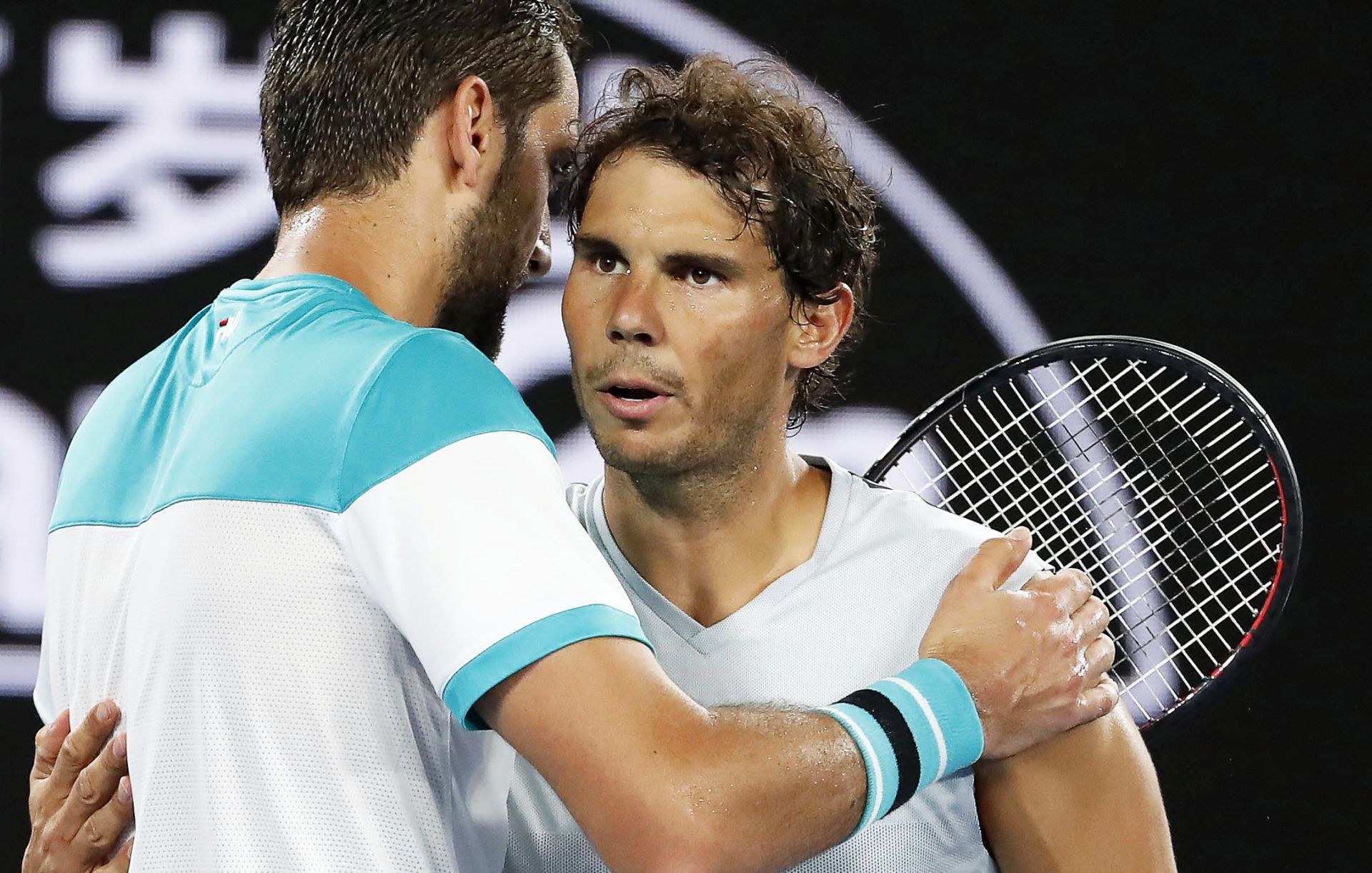 epa06467517 Rafael Nadal (R) of Spain is embraced by Marin Cilic (L) of Croatia after retiring from their quarter final match at the Australian Open Grand Slam tennis tournament in Melbourne, Australia, 23 January 2018.  EPA/MAST IRHAM