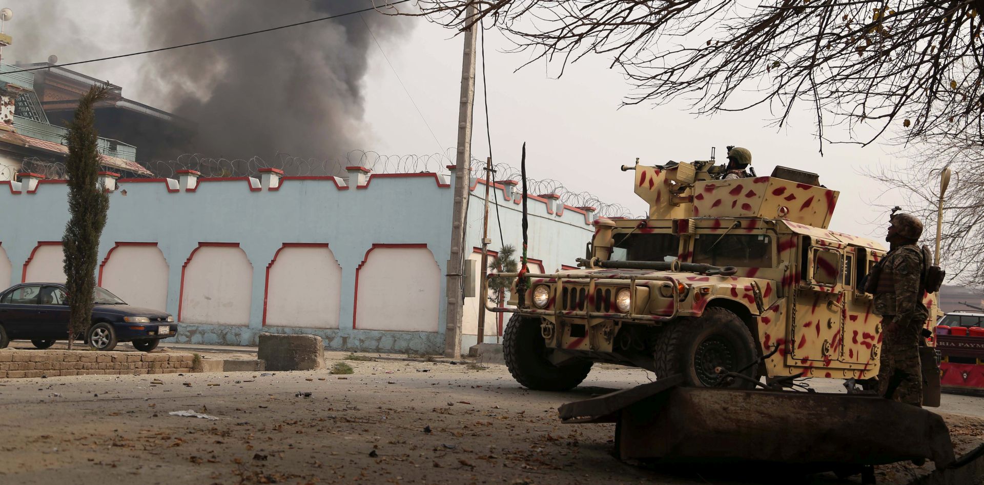 epa06469894 Afghan security officials take position in a nearby building after an attack on the headquarters of the non-governmental organization Save the Children in Jalalabad, Afghanistan, 24 January 2018. At least 11 people were injured when a suicide attacker detonated explosives strapped to his body and a number of insurgents entered the NGO office.  EPA/GHULAMULLAH HABIBI