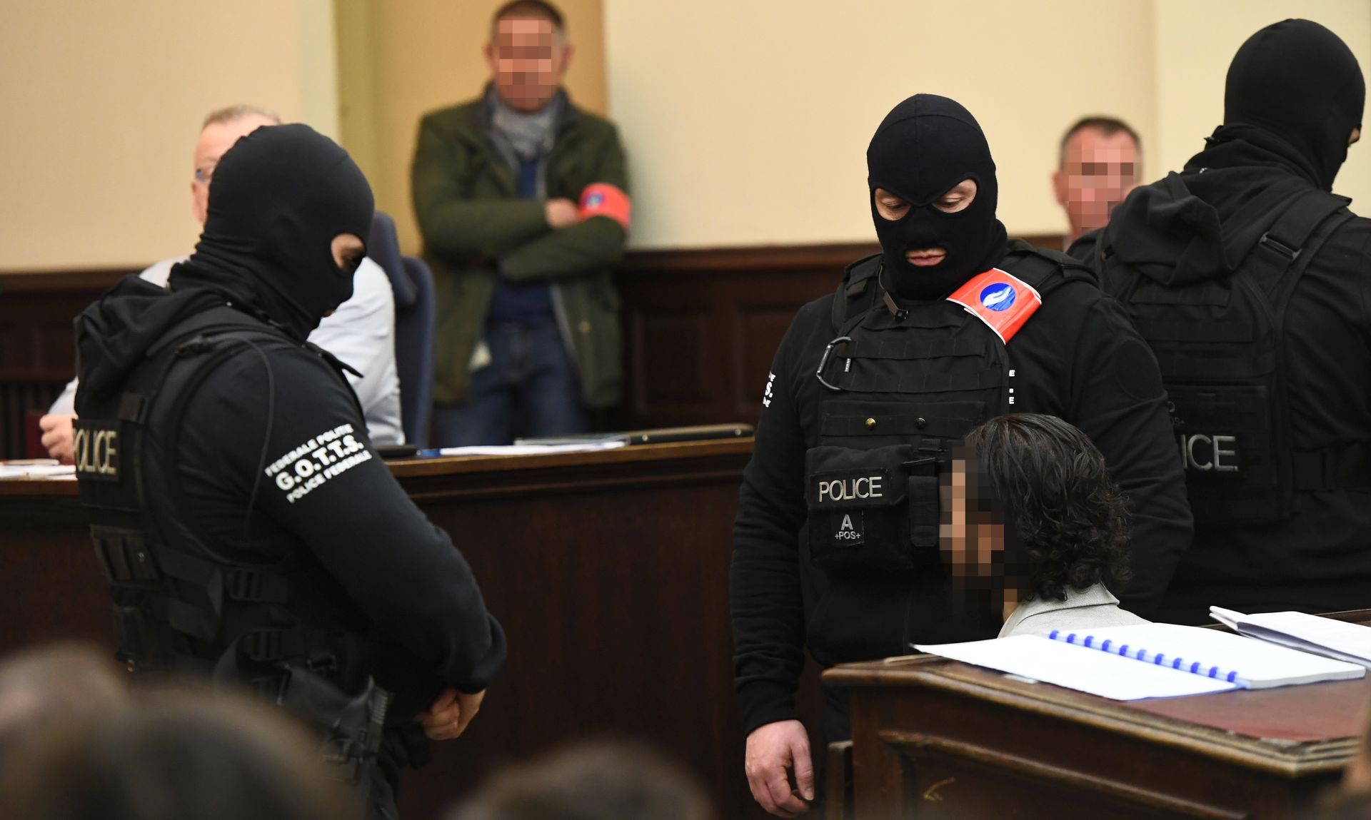 epa06497660 Prime suspect in the November 2015 Paris attacks Salah Abdeslam (C, seated) is surrounded by Belgian special police officers prior to the opening of the trial of  terror suspects Salah Abdeslam and Sofiane Ayari, also known as Amine Choukri, in Brussels, Belgium, 05 February 2018. Terrorist suspects Salah Abdeslam and Sofiane Ayari are on trial for attempted murder of police searching for suspects of the November 2015 Paris terror attacks that left 130 people dead, when Abdeslam was on the run and hiding in the Belgian capital. Abdeslam allegedly escaped a shootout with Belgian police in March 2016 during which he wounded four officers but was captured and arrested some days later in downtown Brussels. The trial in Belgium only deals with the shootout prior to the arrest. His role in the Paris terrorist attacks will be tried in a court in France at a later stage.  EPA/EMANUEL DUNAND / POOL