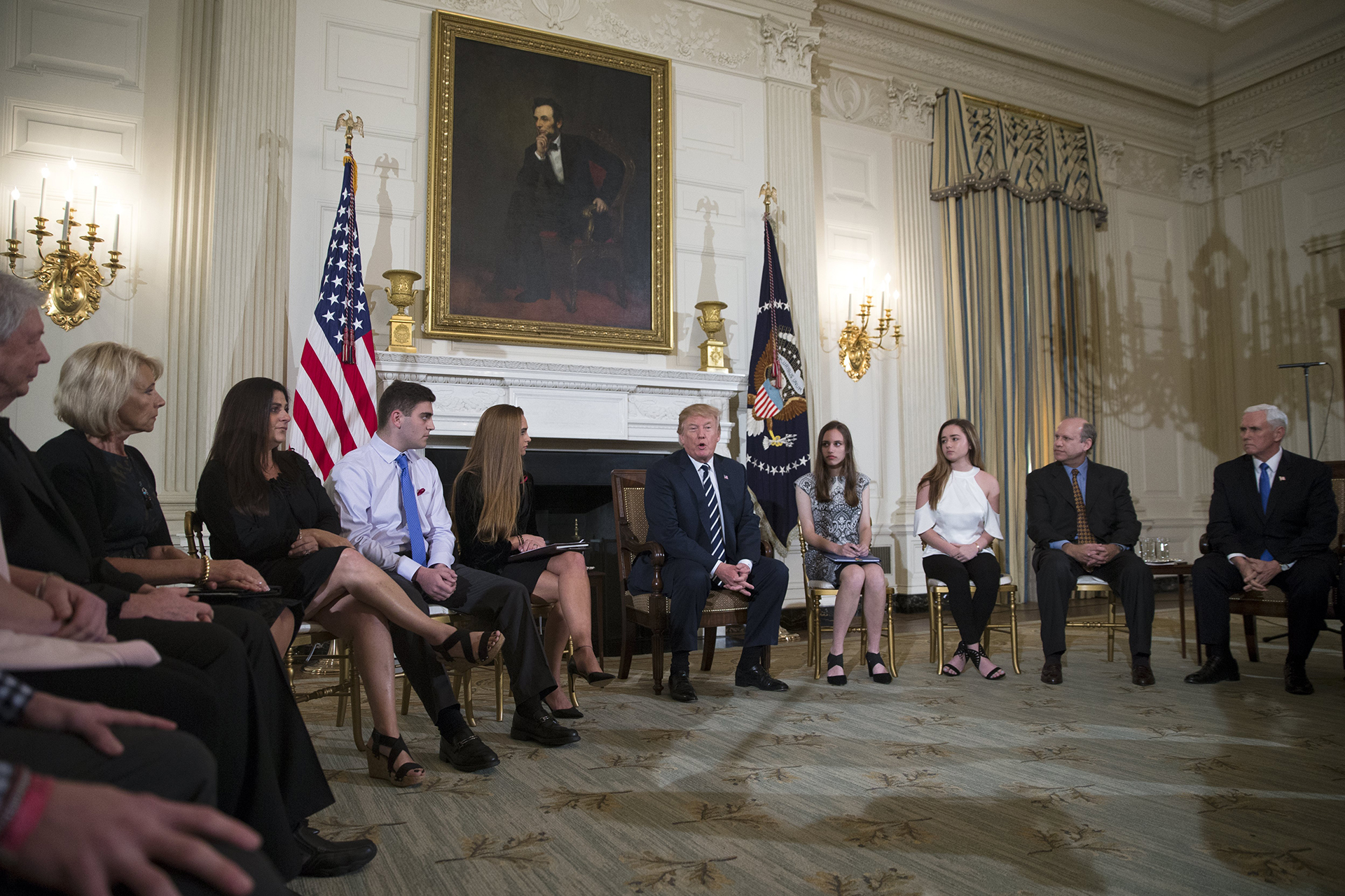 epa06551647 US President Donald J. Trump (C) delivers remarks during a listening session with high school students and teachers in the State Dining Room of the White House in Washington, DC, USA, 21 February 2018. Families from the Parkland, Newtown and Columbine communities attended the meeting.  EPA/SHAWN THEW