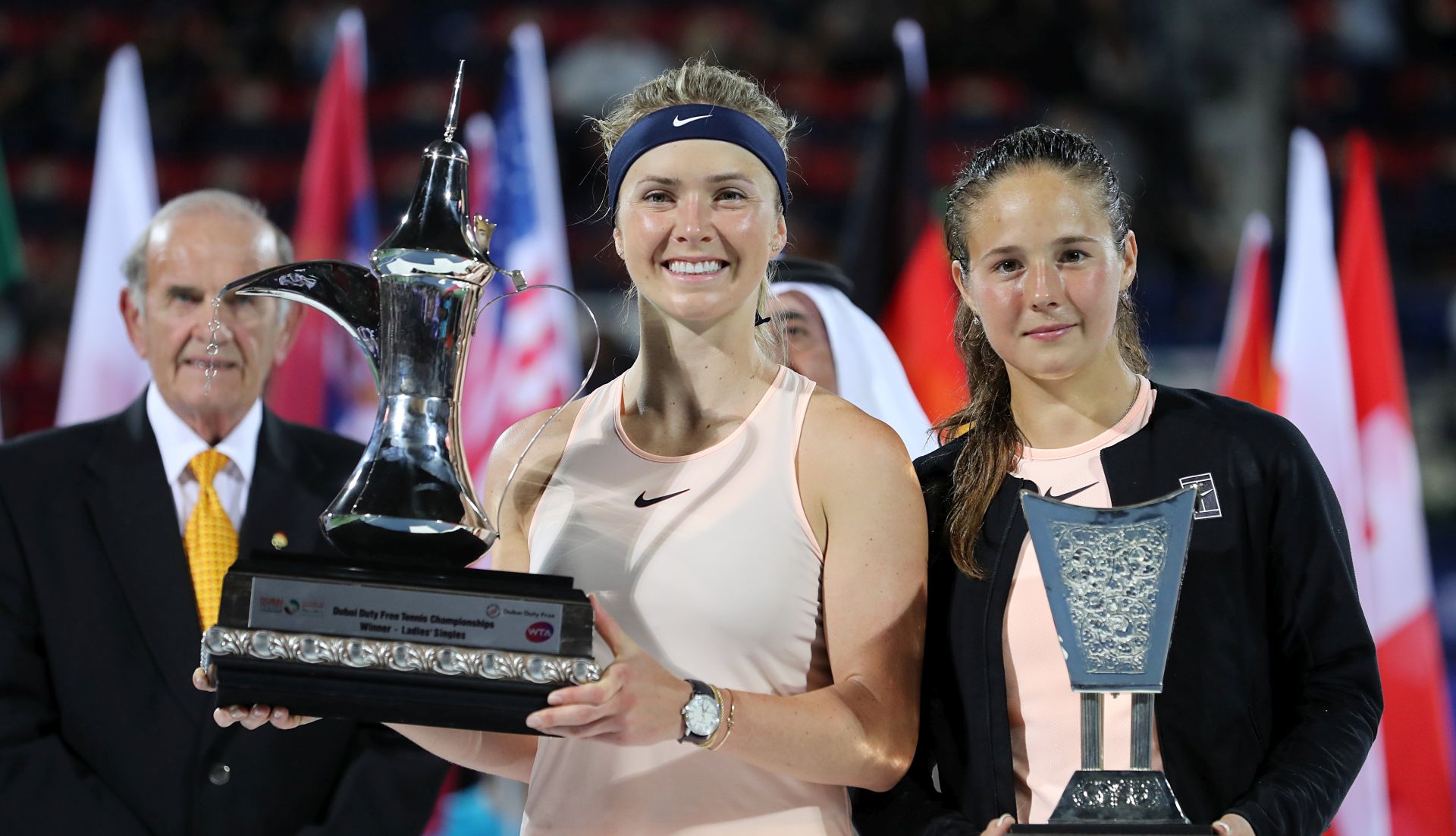 epa06561341 Elina Svitolina (C) of Ukraine poses with her trophy next to Daria Kasatkina (R) of Russia after winning their final match at the Dubai Duty Free Tennis WTA Championships in Dubai, United Arab Emirates, 24 February 2018.  EPA/MAHMOUD KHALED
