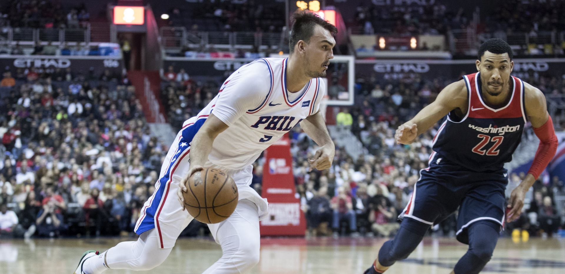 epa06565578 Philadelphia 76ers forward Dario Saric (L) of Croatia dribbles beside Washington Wizards forward Otto Porter Jr. (R) during the first half of the NBA basketball game between the Philadelphia 76ers and the Washington Wizards at Capital One Arena in Washington, DC, USA, 25 February 2018.  EPA/MICHAEL REYNOLDS  SHUTTERSTOCK OUT