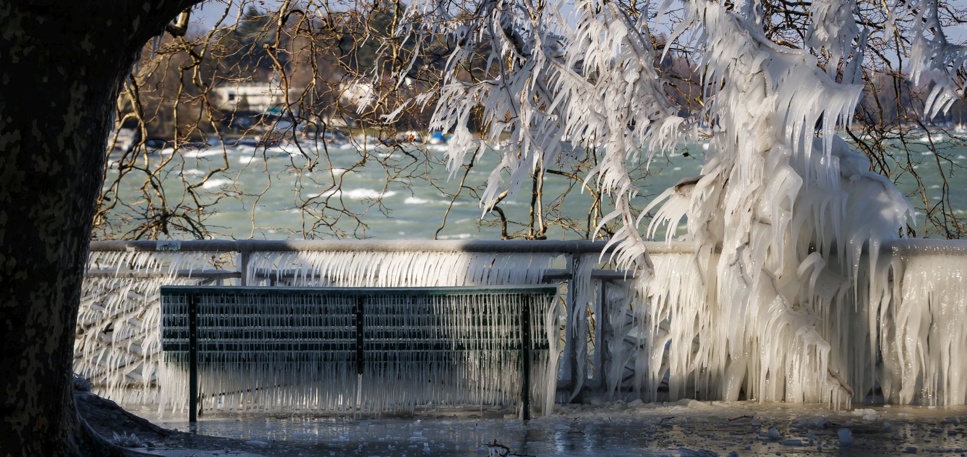 epa06567061 An ice covered bench is pictured at the frozen shore of Lake Geneva during a windy winter day, in Geneva, Switzerland, 26 February 2018. Media reports state that extreme cold weather is forecast to hit many parts of Europe with temperatures plummeting to a possible ten year low.  EPA/VALENTIN FLAURAUD