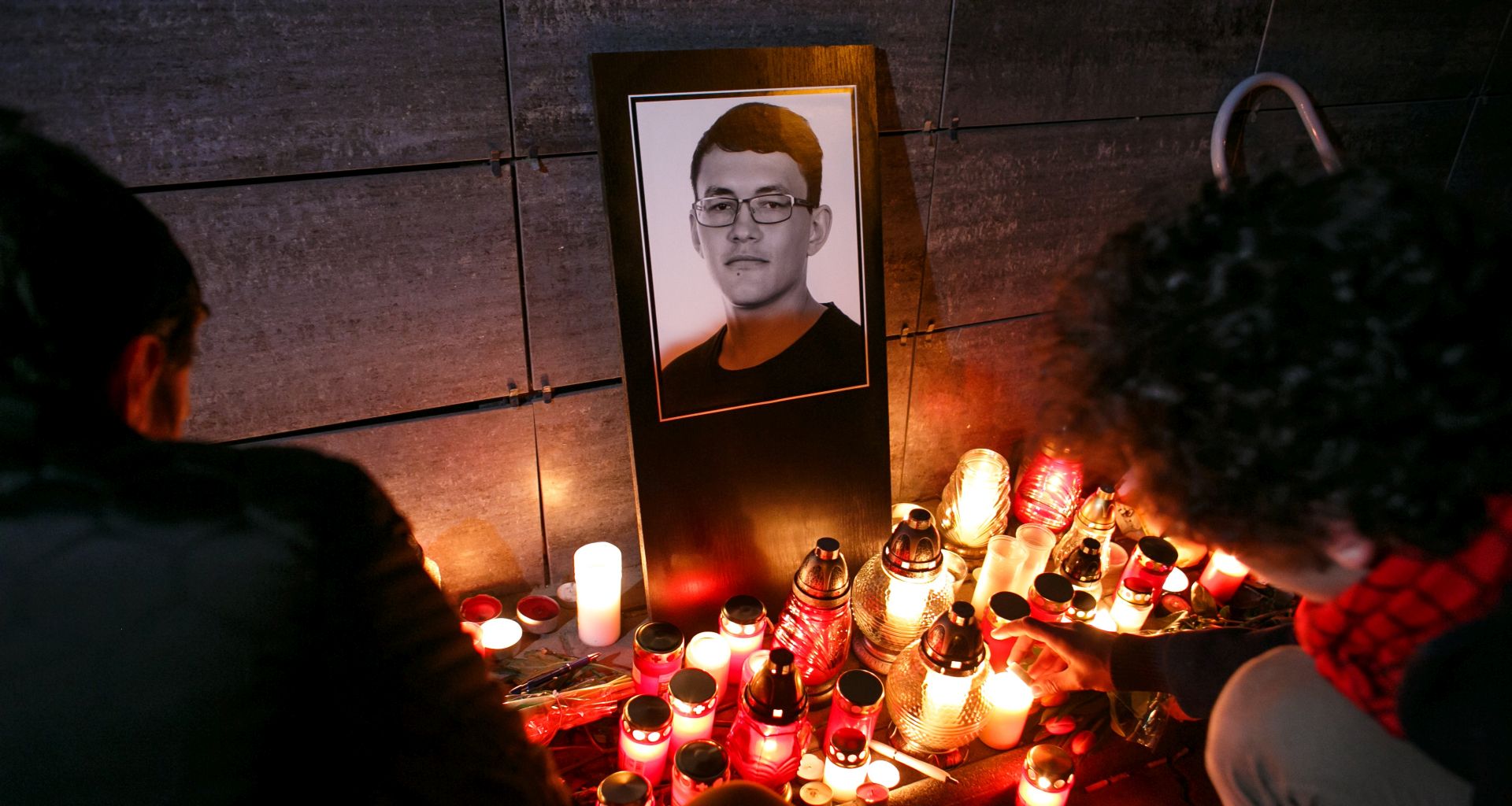 epa06567109 People light candles during a candlelight vigil for murdered Slovak journalist Jan Kuciak in Bratislava, Slovakia, 26 February 2018. Kuciak was found shot dead together with his girlfriend Martina in Velka Maca near Bratislava. The 27-year-old reporter was working for the Slovak news website actuality.sk and specializing on topics of tax evasion. Police suspect that the killing is linked to his investigations.  EPA/DAVID DUDUCZ