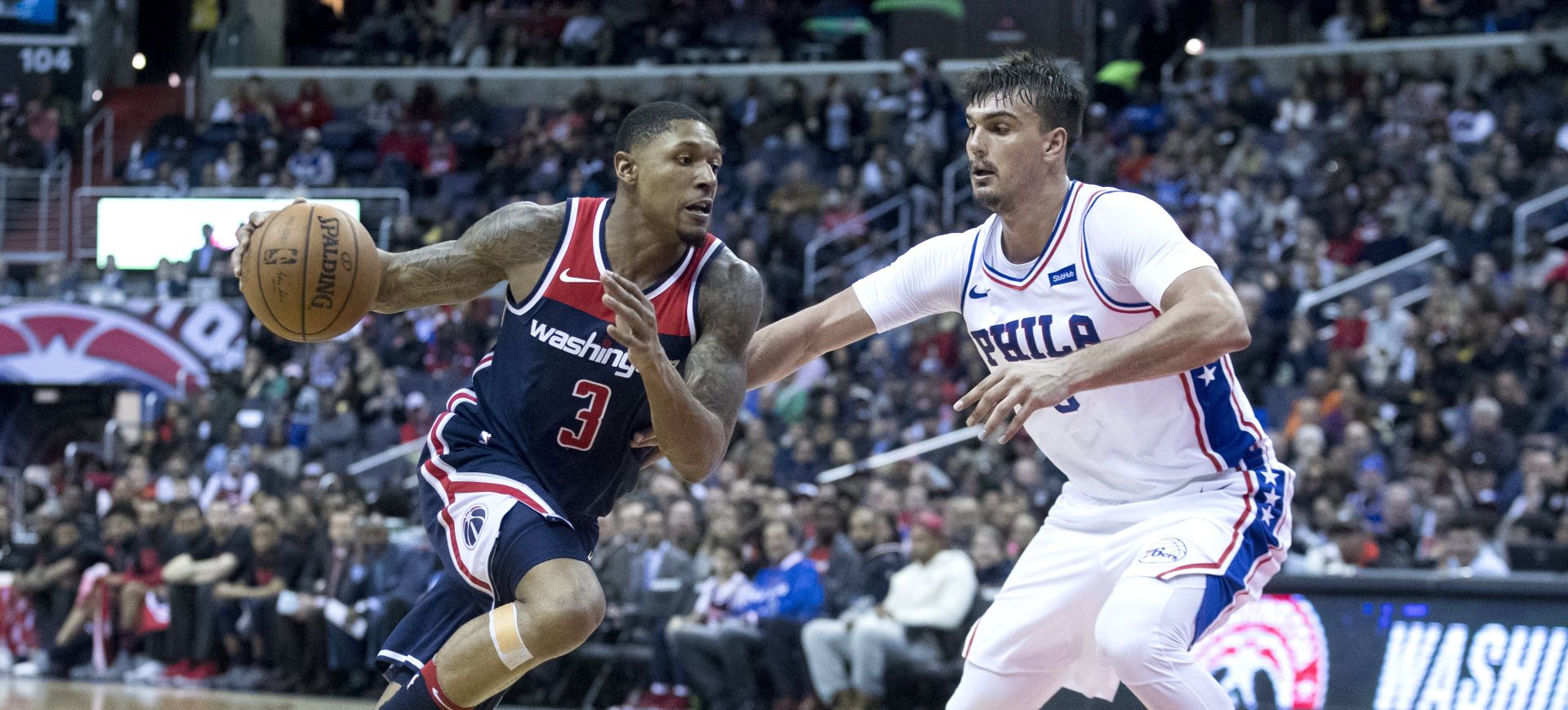 epa06565611 Washington Wizards guard Bradley Beal (L) dribbles beside Philadelphia 76ers forward Dario Saric (R) of Croatia during the second half of the NBA basketball game between the Philadelphia 76ers and the Washington Wizards at Capital One Arena in Washington, DC, USA, 25 February 2018.  EPA/MICHAEL REYNOLDS  SHUTTERSTOCK OUT