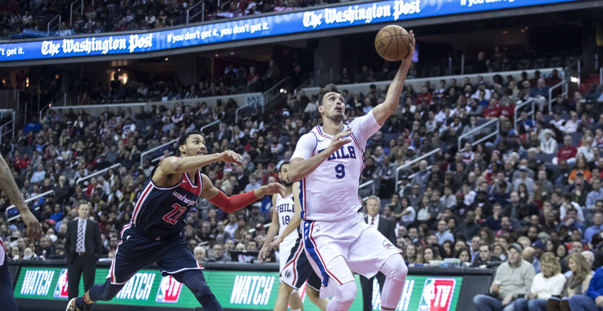 epa06565577 Philadelphia 76ers forward Dario Saric (R) of Croatia drives toward the basket beside Washington Wizards forward Otto Porter Jr. (L) during the first half of the NBA basketball game between the Philadelphia 76ers and the Washington Wizards at Capital One Arena in Washington, DC, USA, 25 February 2018.  EPA/MICHAEL REYNOLDS  SHUTTERSTOCK OUT