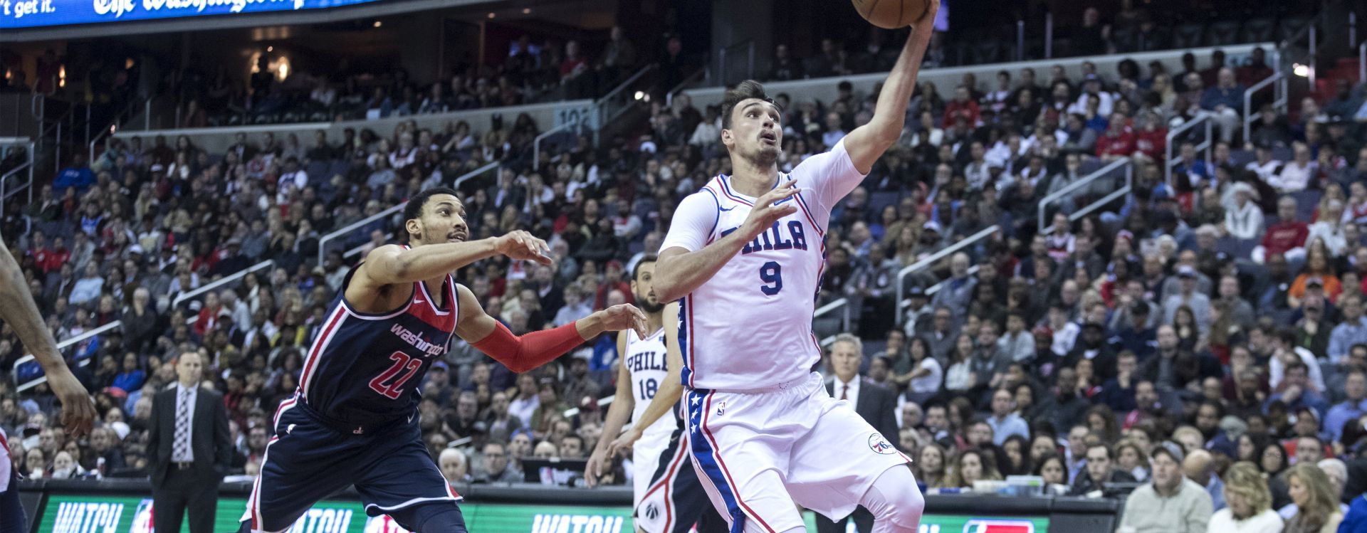 epa06565577 Philadelphia 76ers forward Dario Saric (R) of Croatia drives toward the basket beside Washington Wizards forward Otto Porter Jr. (L) during the first half of the NBA basketball game between the Philadelphia 76ers and the Washington Wizards at Capital One Arena in Washington, DC, USA, 25 February 2018.  EPA/MICHAEL REYNOLDS  SHUTTERSTOCK OUT