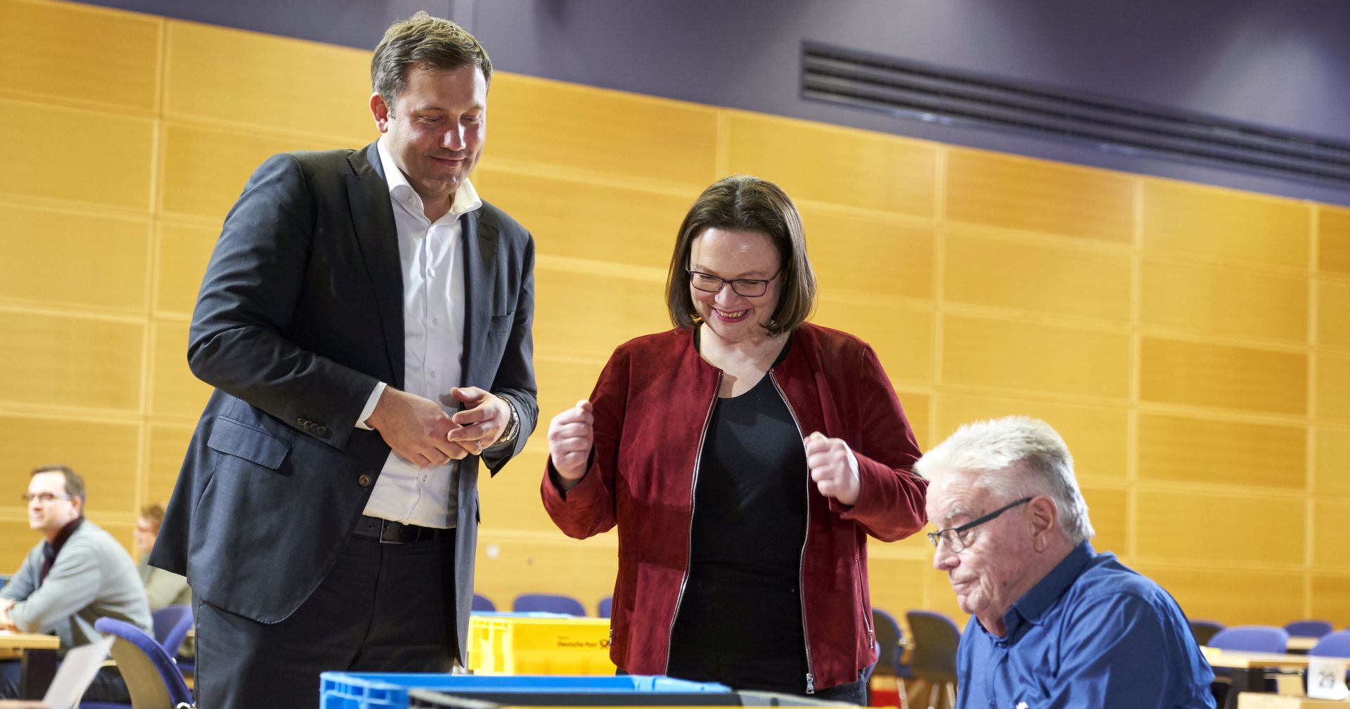 epa06577935 Chairman of the Social Democratic Party (SPD) parliamentary group Andrea Nahles (C) and Secretary General Lars Klingbeil (L) talk to a member of the SPD while he counts votes for the government coalition agreement with the Christian Democratic Union (CDU) at the Willy-Brandt-Haus in Berlin, Germany, 03 March 2018. About 463,000 members of the SPD voted on the coalition agreement with the CDU and Christian Social Union (CSU) from 20 February to 02 March. The votes will be counted on 03 March at the SPD headquarters in Berlin and the result is expected to be announced on 04 March.  EPA/HENNING SCHACHT / POOL