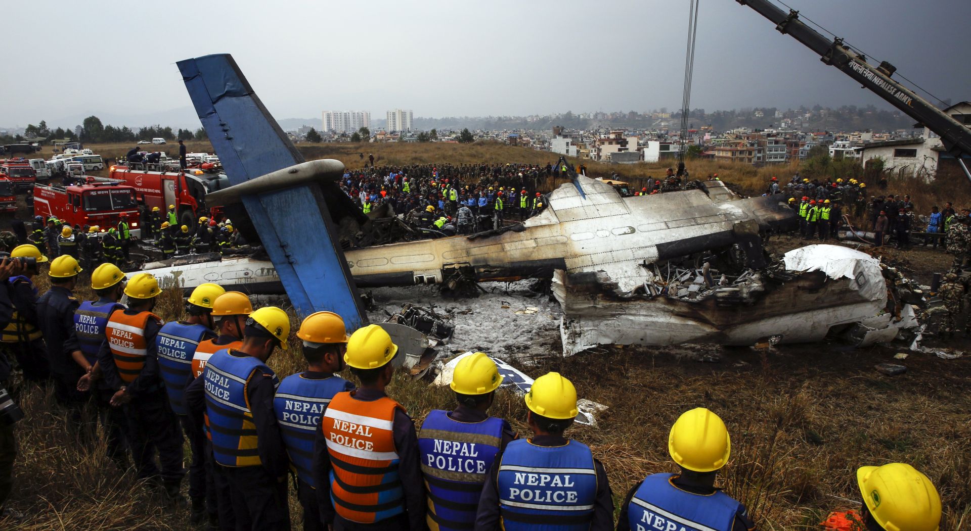 epa06598026 Rescue teams next to a wreckage of a plane that crashed at the main airport Tribhuvan International Airport in Kathmandu, Nepal, 12 March 2018. According to reports, Bangladeshi US-Bangla plane had crashed while landing at the airport with 71 passengers and crew onboard. According to Nepalese officials at least 38 people have been killed, 23 injured and 10 unaccounted in the crash.  EPA/NARENDRA  SHRESTHA