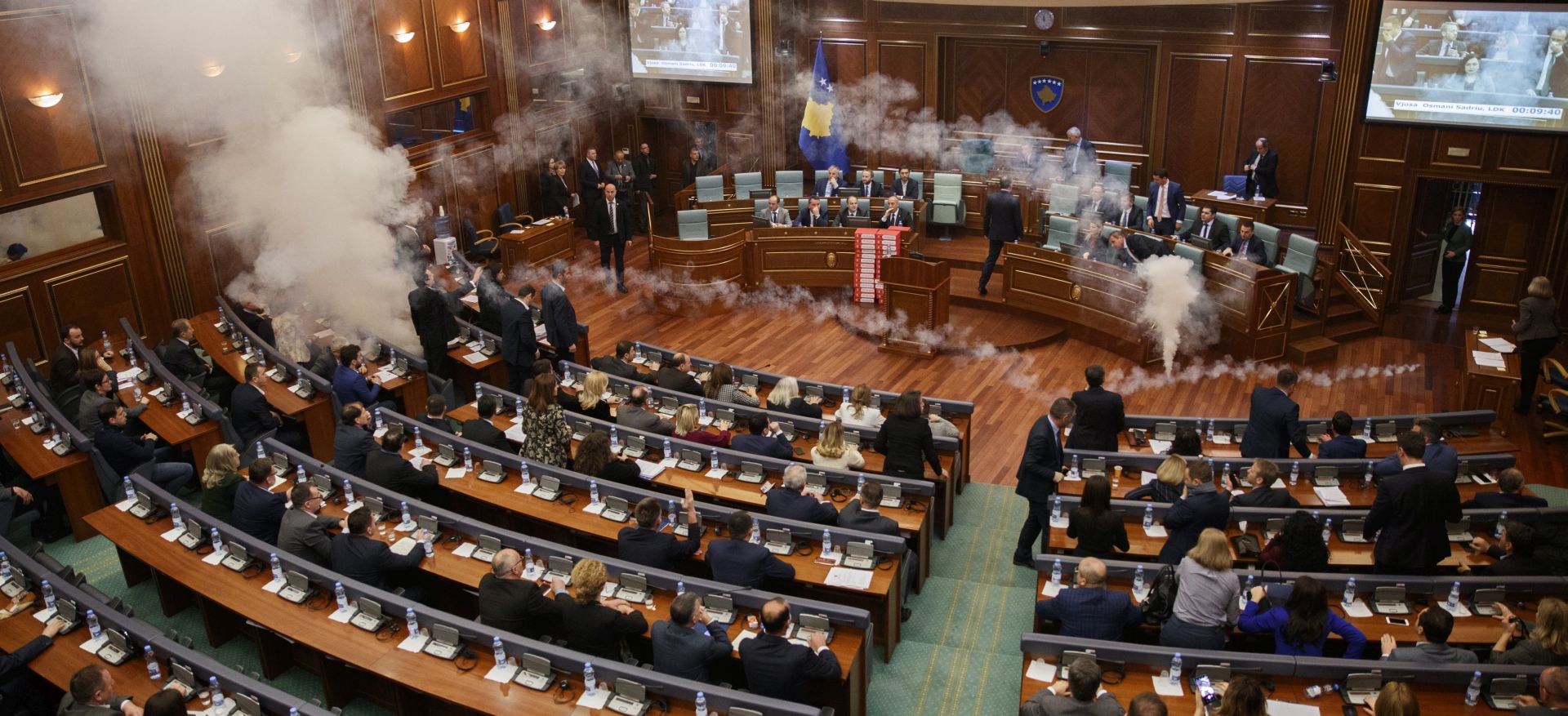 epa06617418 Tear gas rises from canisters released by Kosovo opposition lawmakers before the vote on an agreement on border demarcation with Montenegro during a parliamentary session in Pristina, Kosovo, 21 March 2018. Ratification of the border agreement between Kosovo and Montenegro is set by European Union as the main condition before it will grant Kosovo nationals visa-free access to the Schengen area.  EPA/VALDRIN XHEMAJ