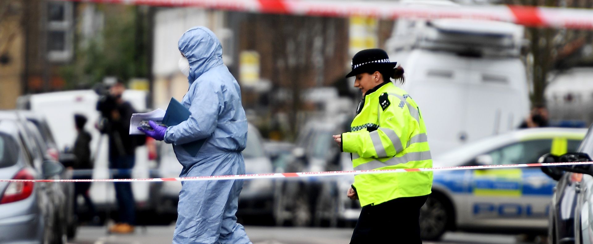 epa06642795 Police and forensic officers work at the scene of a gun crime in Tottenham, in the north of London, Britain, 03 April 2018. A 17-year-old girl reportedly was shot dead in Tottenham on 02 April night night and was pronounced dead at the scene. In other incidents not far from this crime a boy was found with shot wounds and another boy with stab wounds, although police reportedly does not link the crimes with each other. Media reports in the past days stated that violent crimes are on the increase in the British capital with murder rates in the meantime narrowing to the figures known of the US metropole New York.  EPA/ANDY RAIN