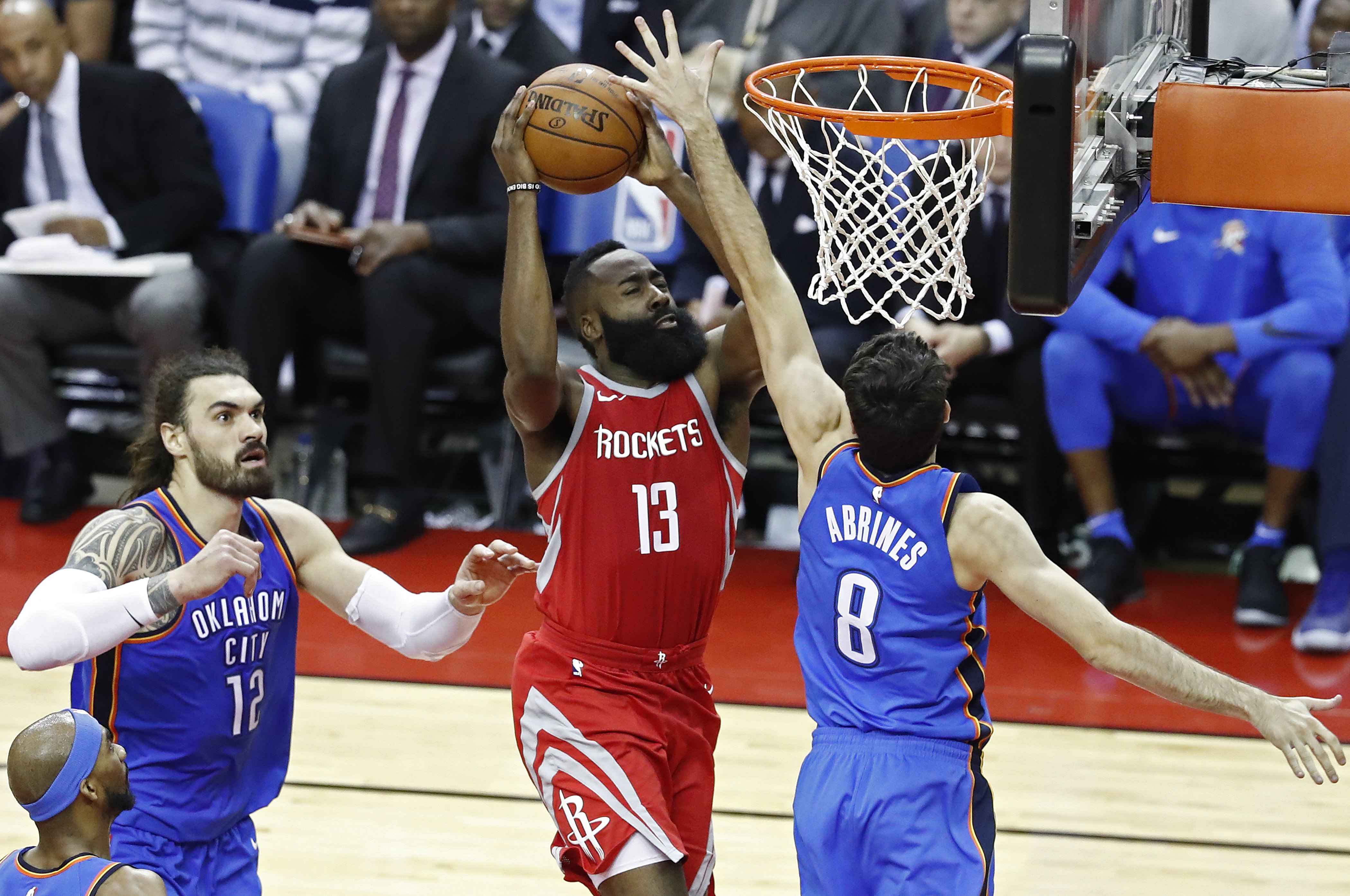 epa06653976 Houston Rockets player James Harden (C) goes to the basket against Oklahoma City Thunder player Alex Abrines (R) in the second half of their NBA basketball game at the Toyota Center in Houston, Texas, USA, 07 April 2018.  EPA/LARRY W. SMITH  SHUTTERSTOCK OUT