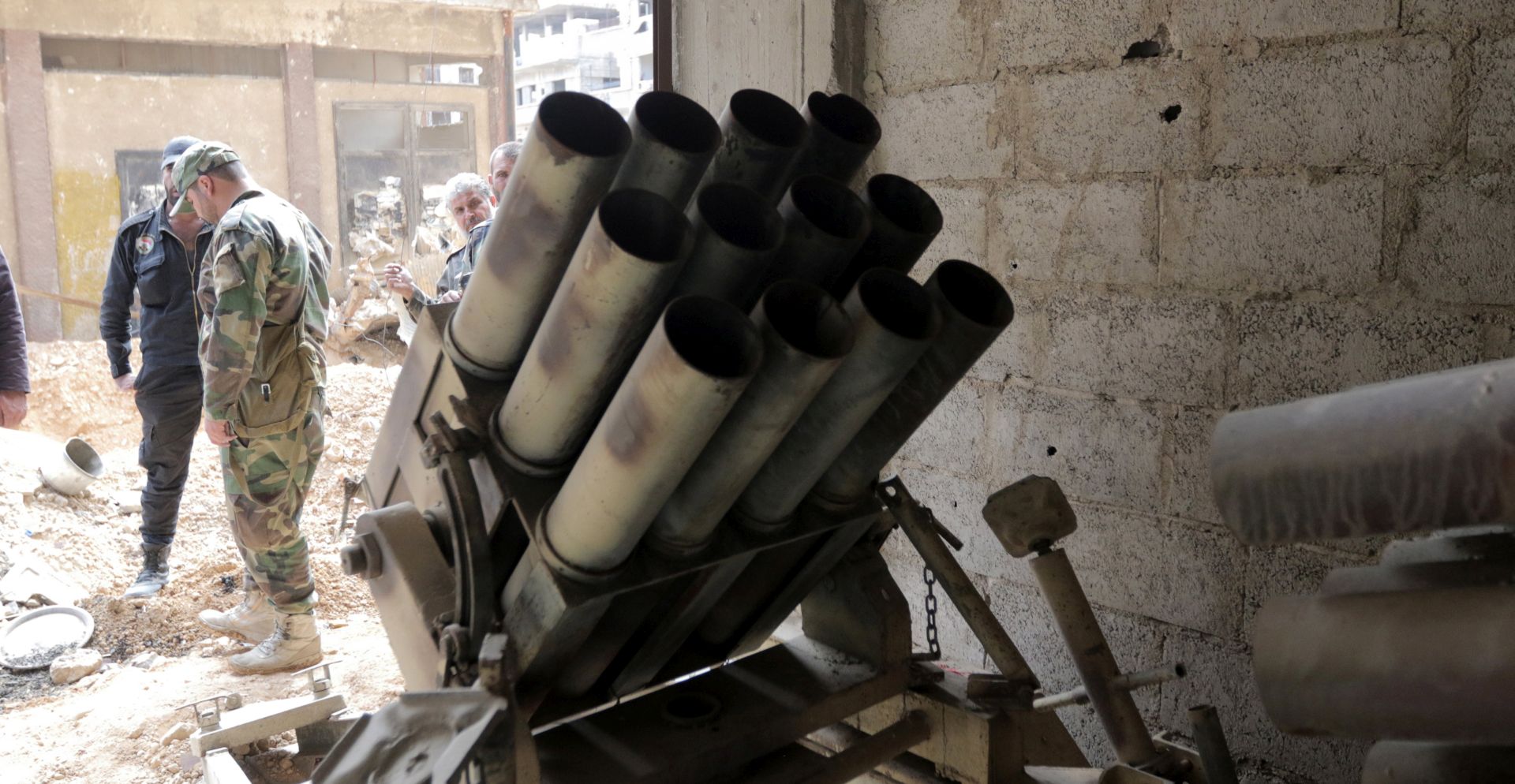 epa06655283 A Syrian soldier inspects weapons and ammunition depot at a room, in Zamalka town, Eastern Ghouta, in the countryside of Damascus, Syria, 08 April 2018. The city was recently recaptured by the Syrian government during a military offensive that was launched more than a month ago against rebels.  EPA/YOUSSEF BADAWI