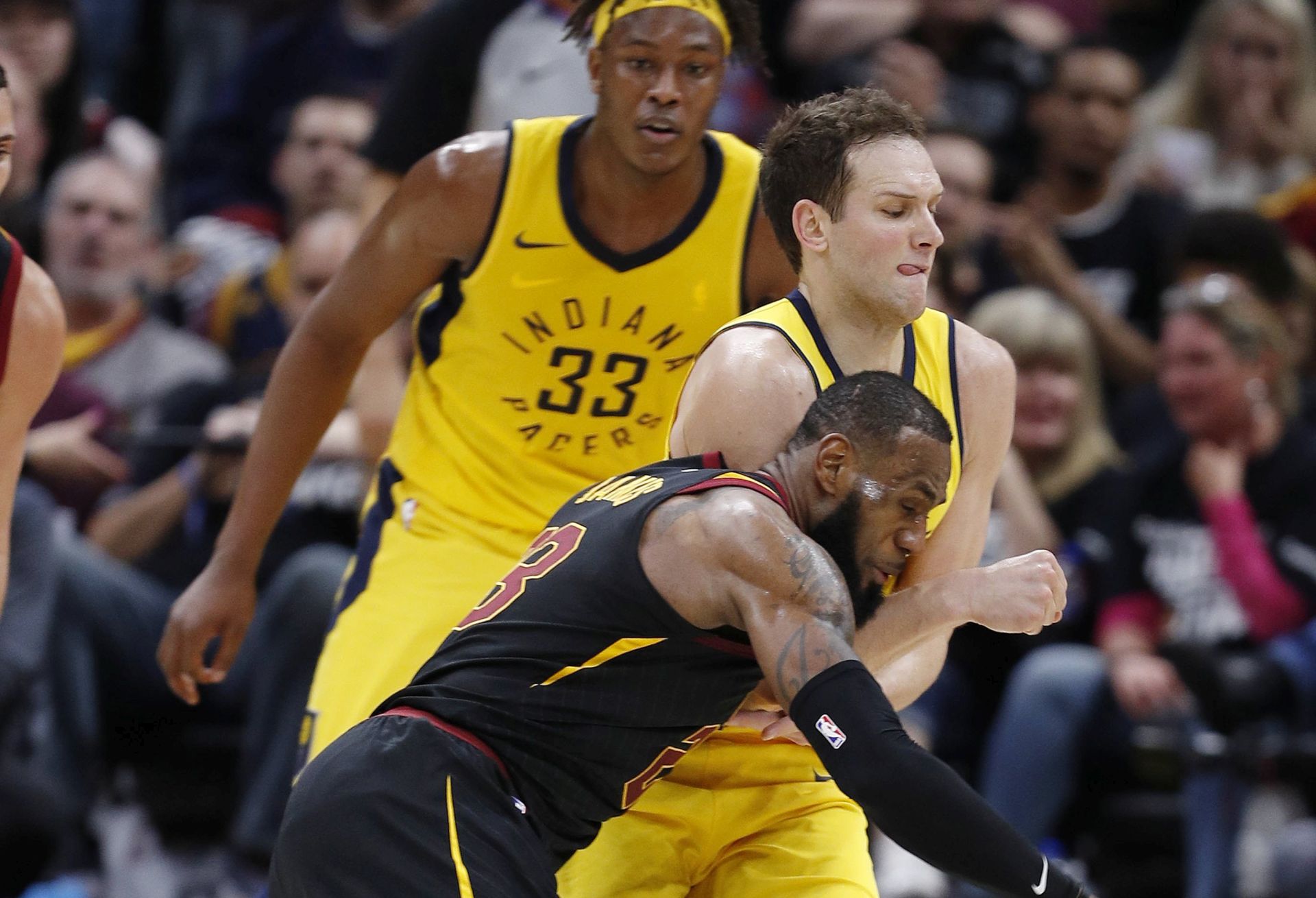 epa06672080 LeBron James (front) of the Cleveland Cavaliers fouls Indiana Pacers forward Bojan Bogdanovic of Croatia (C) as Pacers Myles Turner (back) looks on during the second half of game 1 of the Eastern Conference First Round Playoffs at Quicken Loans Arena in Cleveland, Ohio, USA, 15 April 2018.  EPA/DAVID MAXWELL  SHUTTERSTOCK OUT