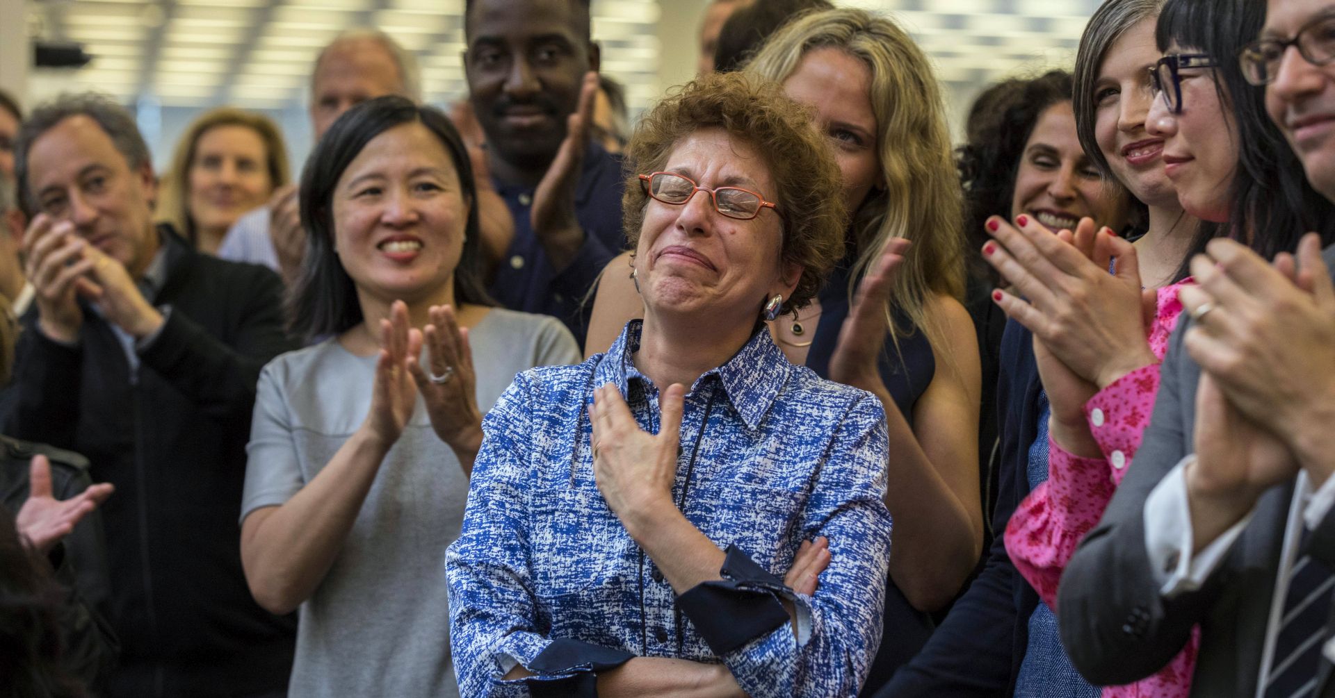 epa06673840 A handout photo made available by the New York Times shows Susan Chira, manager of newsroom mentorship, being applauded by colleagues in the newsroom at The New York Times after newspaper won the 2018 Pulitzer Prize for Public Service in New York, New York, USA, on 16 April 2018. The Times shared the prize with Ronan Farrow of The New Yorker for their reporting on sexual harassment that ushered in a reckoning about the treatment of women by powerful men in the uppermost ranks of Hollywood, politics, media and technology.  EPA/HIROKO MASUIKE / THE NEW YORK TIMES / HANDOUT  HANDOUT EDITORIAL USE ONLY/NO SALES