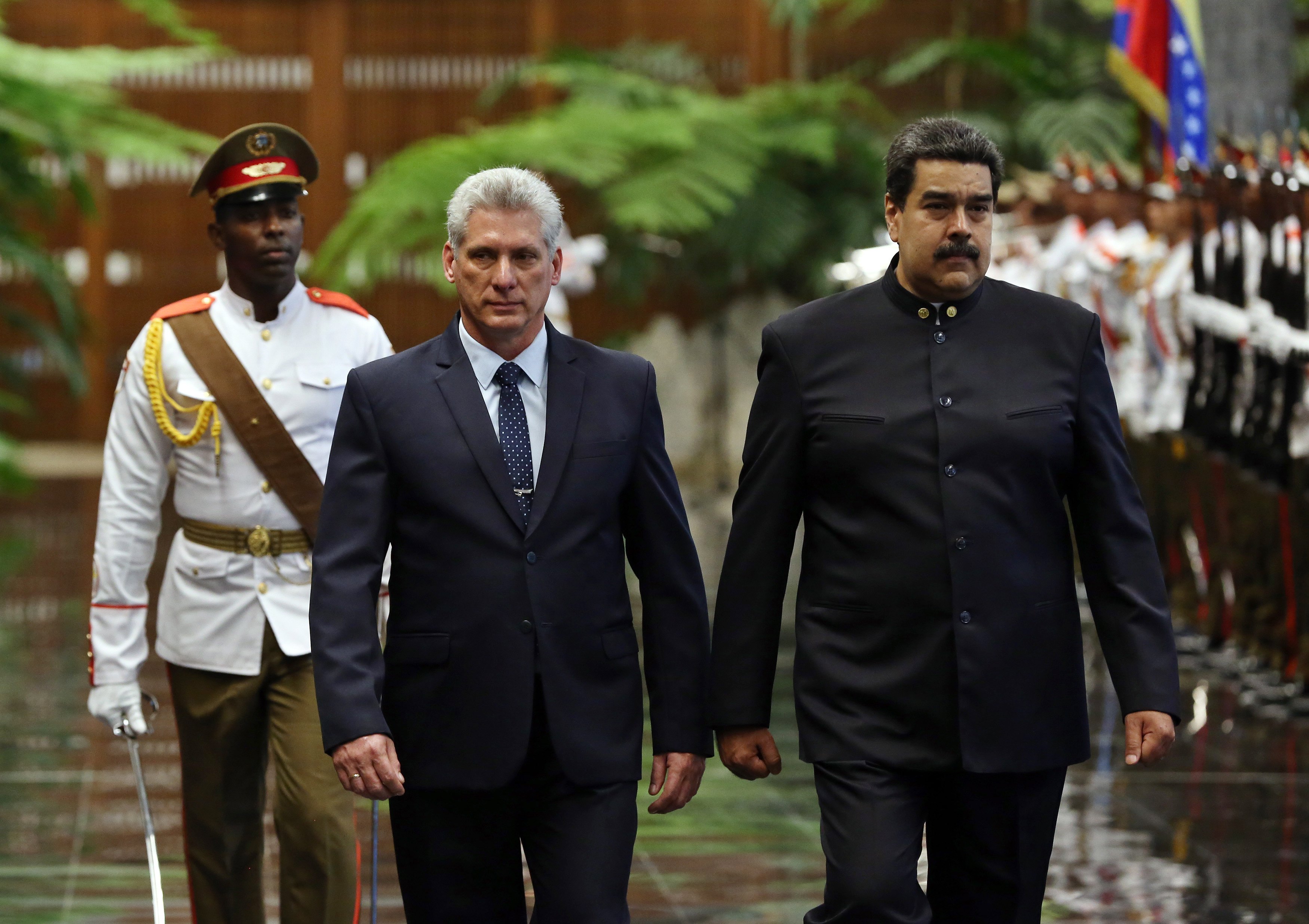 epa06683931 President of Cuba Miguel Diaz-Canel (L) and his Venezuelan counterpart Nicolas Maduro (R) review the troops formed for the official reception ceremony at the Palace of the Revolution in Havana, Cuba, 21 April 2018. The new President of Cuba Miguel Diaz-Canel received at the Palace of the Revolution of Havana his Venezuelan counterpart Nicolas Maduro, the first head of state to visit the island after the presidential relay that took place this week in Cuba.  EPA/Alejandro Ernesto